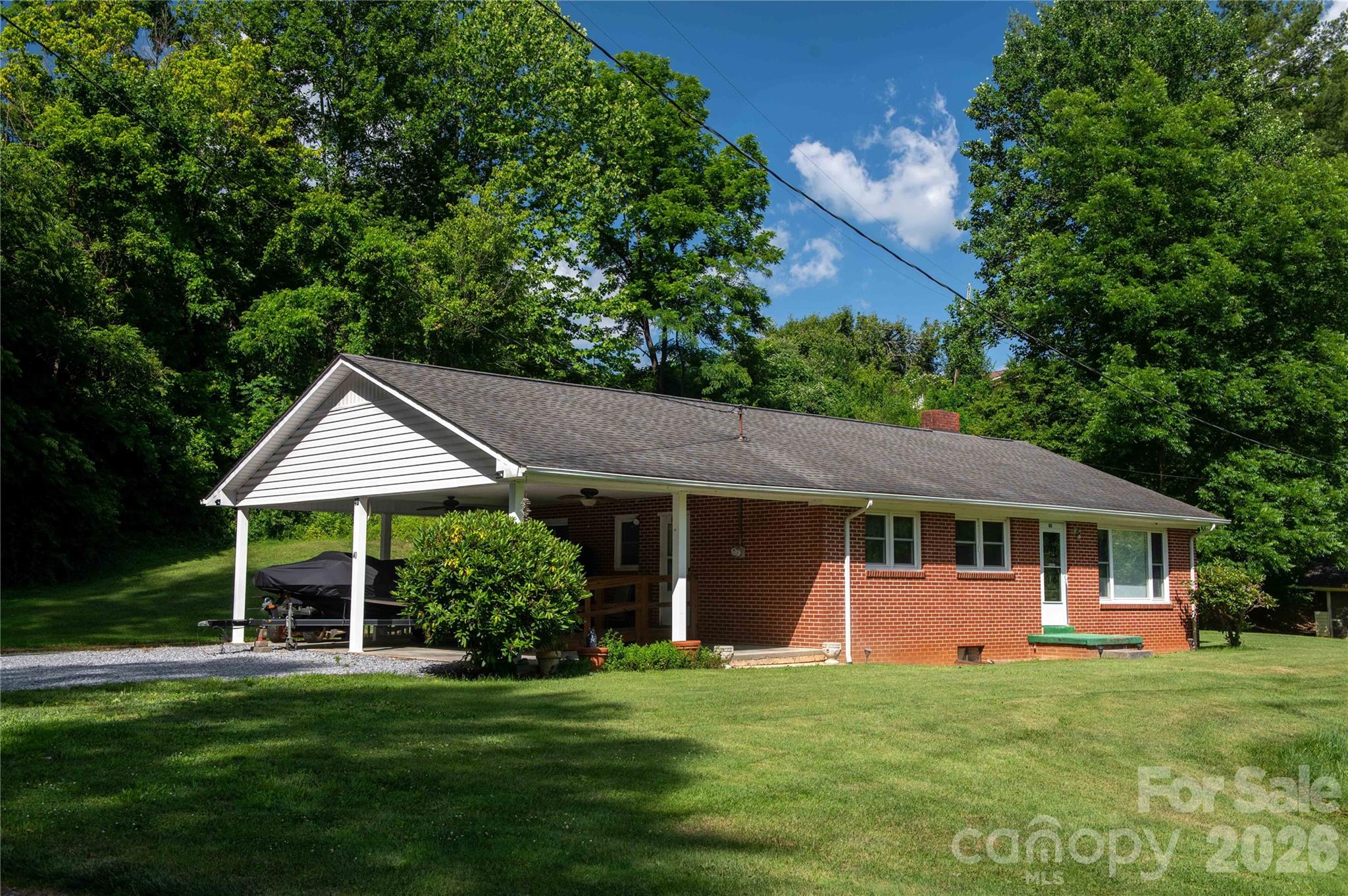 Imagine drifting off to sleep to the gentle, soothing sounds of a burbling creek not far from your bedroom window. Welcome to this charming 3-bedroom, 1-bath brick home, where peaceful mountain living meets everyday convenience. Inside, you’ll find a cozy kitchen  and a dedicated dining space perfect for family meals. The massive full basement is a blank canvas with endless potential—transform it into a home gym, a vibrant entertainment hub, or finish it out for additional living space.  Both main floor access and basement access to the large car port allows you to get to your vehicle despite inclement weather, as well as plenty of parking space. 

Wrapped in a classic, low-maintenance brick exterior, this home offers timeless curb appeal and durability. Location is everything: you're just minutes from national parks, the Blue Ridge Parkway, and local shopping, all while centrally located only about an hour to Asheville, or slightly more to Boone and Blowing Rock in the other direction. Enjoy the best of both worlds—serene nature and vibrant urban amenities. Don’t wait on this one; schedule your private showing today!