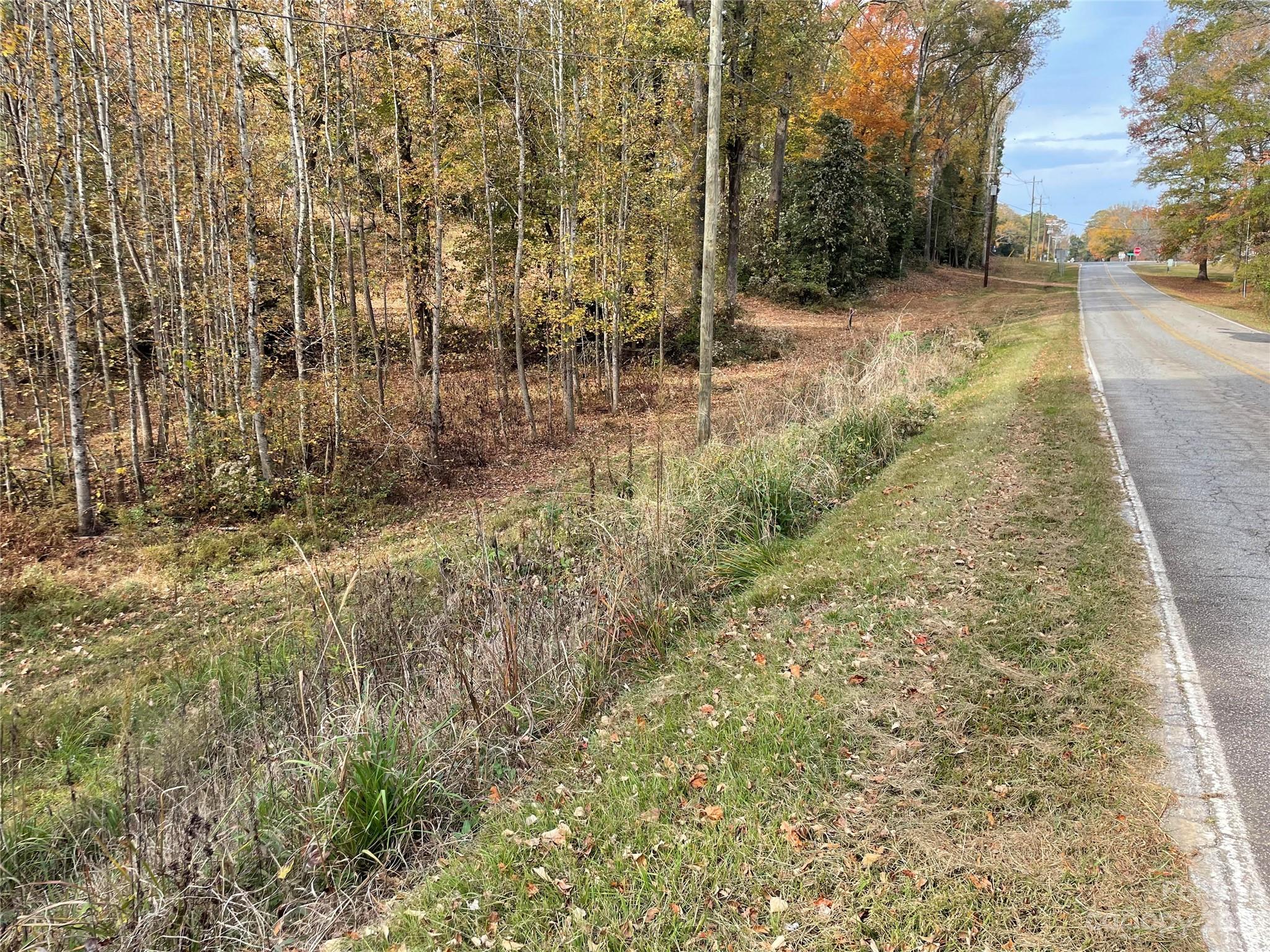 Build your new custom home right here on 2.36 lushes acres in the highly desirable town of Van Wyck. You get to enjoy the perfect mix of small town serenity, stately custom homes all while just a short distance to all Indian Land, Lancaster and South Charlotte have to offer.  This lot is located right in the heart of town near the community center and new playground available for all to enjoy.  Almost 400ft of road frontage. Nestle your new home amongst the natural and lush hardscapes or carve out your ultimate home pad. You do not want to miss out on this rare opportunity in a prime location. County water hook-up available. No HOA. The town of Van Wyck is adjacent to Waxhaw, NC. Easy access to highways, 5, 521, 21 and 77.  Please use 965 W Rebound Road Lancaster SC 29720 for GPS.  Lot is located behind property facing Old Hickory Road, look for sign.