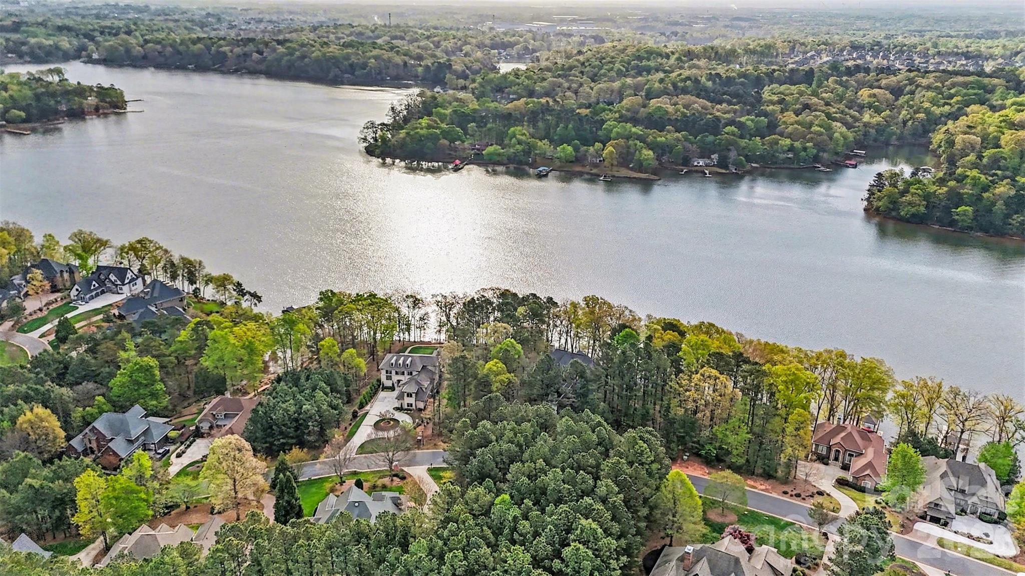 Exceptional property with long shoreline (approximately 108 feet of waterfront) and stunning open water views.  This dockable lot offers the perfect blend of beauty and functionality, featuring a relatively flat to gently sloping topography, a build-friendly terrain rarely found on the water. Ideal for creating a custom home with seamless indoor-outdoor living, private dock access, and unforgettable sunrise and sunset views.  A standout homesite for those seeking the ultimate lake lifestyle.  This lot is located in highly sought- after, amenity rich Reflection Pointe gated community.
