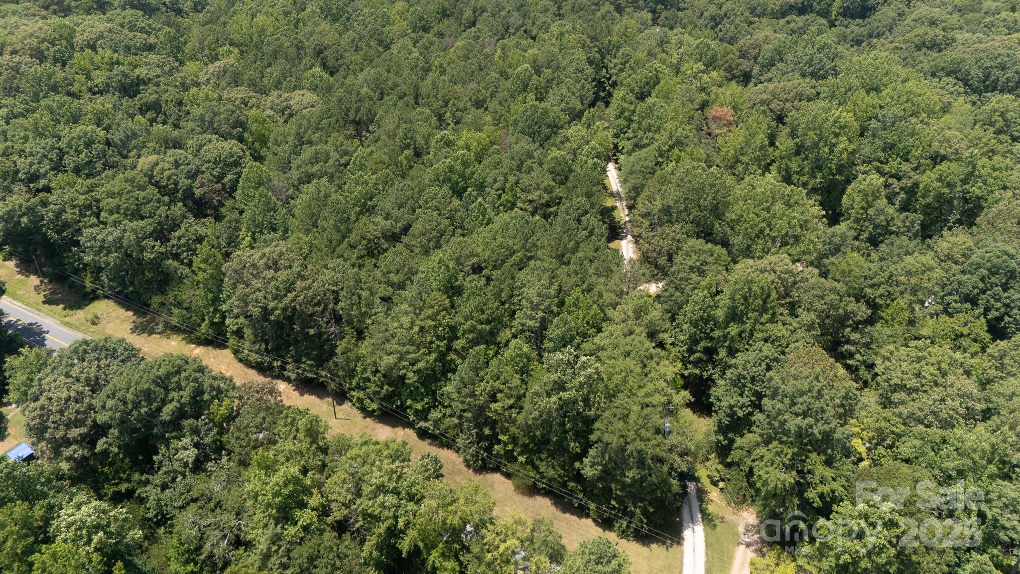 Land, Land, Land!   Build your dream home on this tract of 5 beautiful acres zoned AGC.  This parcel is part of 435-00-00-011 and the 5 acres is being surveyed off.  This tract is very private and has a bevy of hardwood trees and pines.  A deeded road easement runs on the right side of the road-frontage tract.  Location is private and is conveniently located near Chester, York and McConnells with a straight path to I-77, Exit 82 in Rock Hill for Charlotte commuters