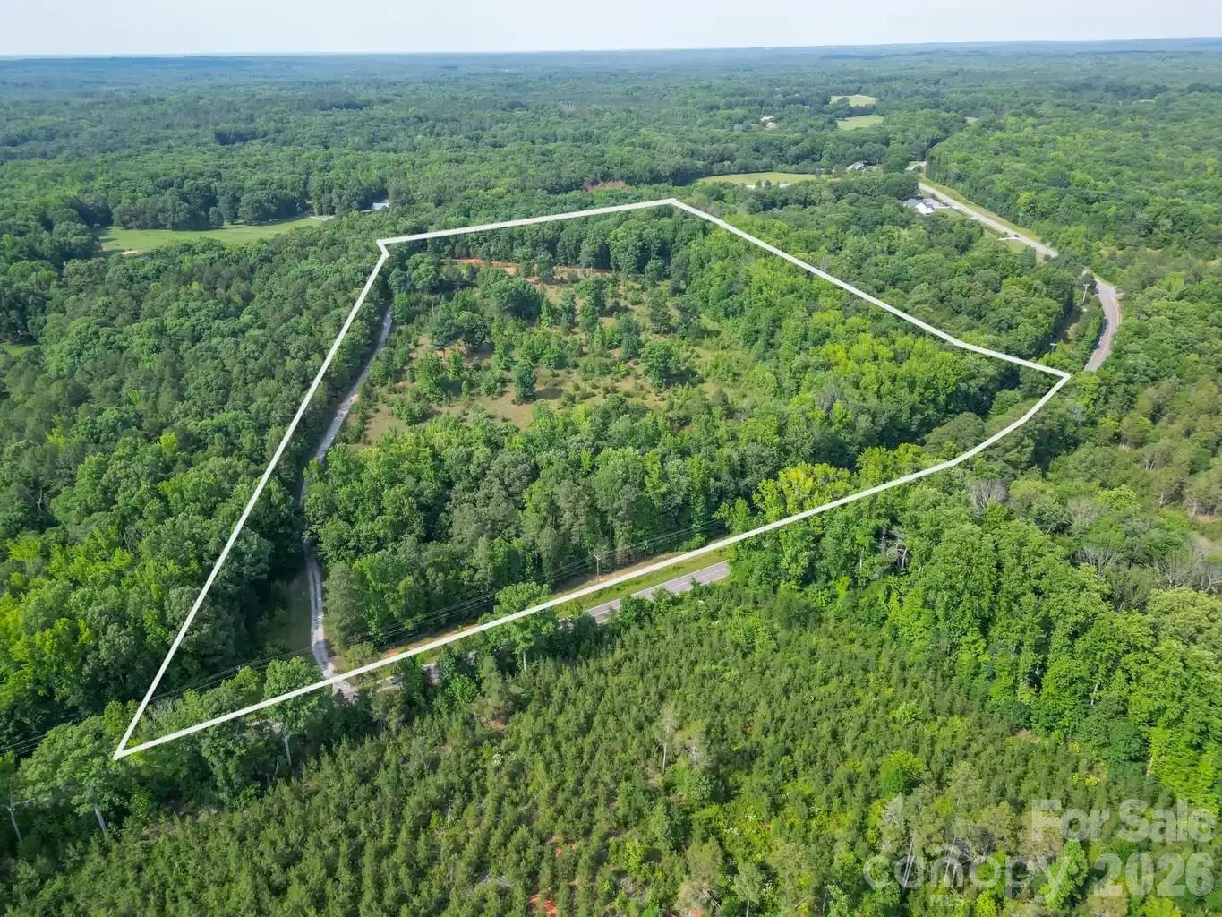 Nestled along scenic Tirzah Church Road and a part of the beautiful The Farms at Heartwood community, this exceptional 24-acre property offers a rare opportunity to own a private piece of Union County countryside. Featuring gently rolling terrain, mature hardwoods, and a picturesque pond, the land provides a stunning backdrop for your dream home, family estate, equestrian property, hobby farm, or private retreat.

A unique highlight of this property is its proximity to the horse trails within The Farms at Heartwood, offering an incredible opportunity for equestrian enthusiasts to enjoy riding through the area's scenic countryside. With plenty of room for barns, paddocks, and riding amenities, this tract is perfectly suited for those seeking an equestrian lifestyle.

Enjoy the peace and privacy of country living while remaining just minutes from historic downtown Waxhaw, where you'll find charming shops, local dining, and community events. Whether you're looking to build your forever home, establish a private retreat, or invest in land for the future, this remarkable property offers the space, beauty, and flexibility to bring your vision to life.

Rarely does a tract of this size, beauty, and location become available, don't miss the opportunity to own a true countryside retreat in one of Waxhaw's most desirable areas.