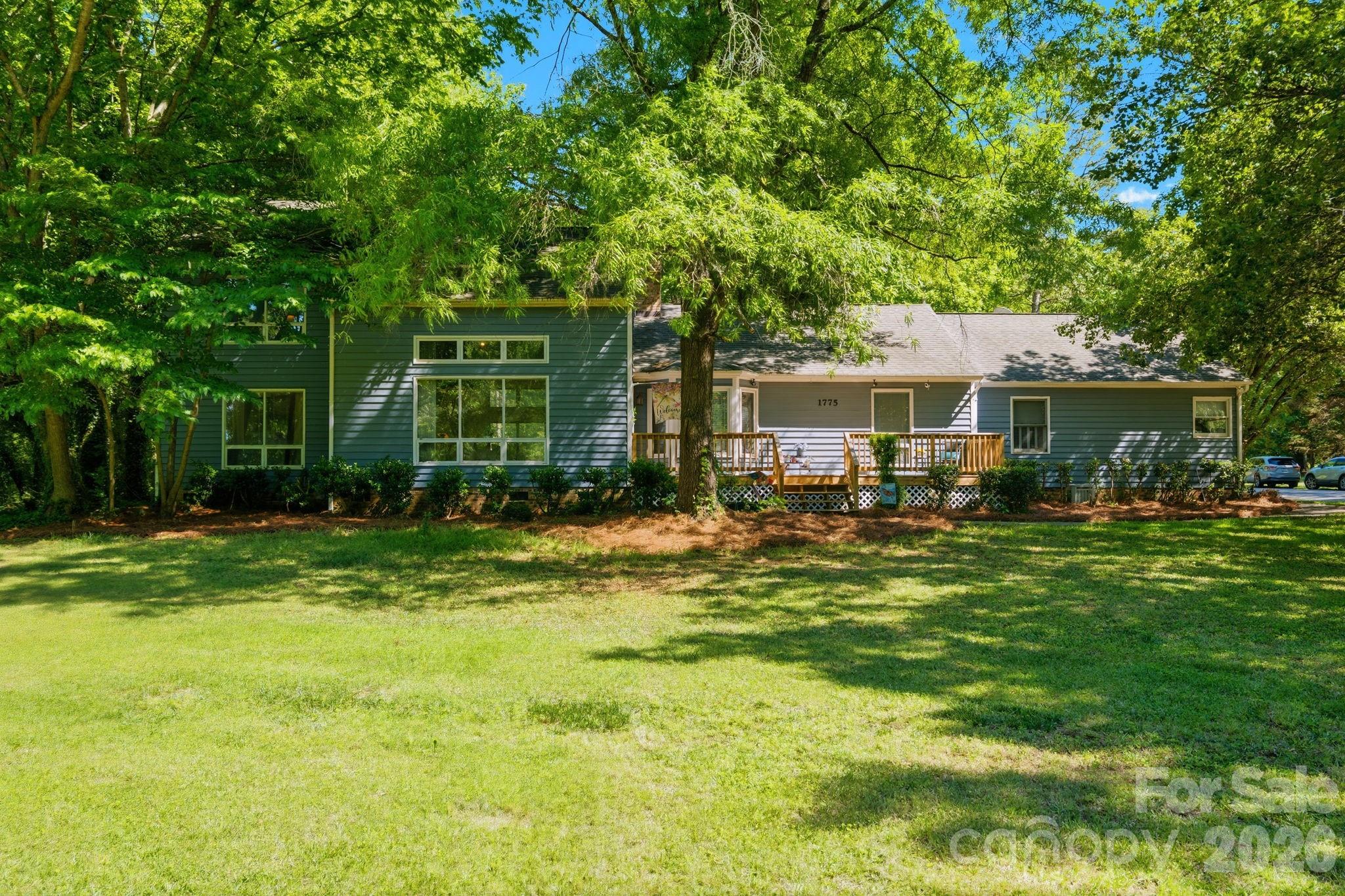 Location, Location, Location! This Fort Mill, SC home offers the ideal combination of space, privacy, and convenience. If you have been searching for a large yard, this property delivers with an expansive front and backyard and plenty of room to add a pool. With both septic and well, you can have your preferred pool company explore all the possibilities. The home is being SOLD AS IS, presenting a great opportunity to customize and make it truly your own. Step onto the new front deck, a perfect spot to unwind at the end of the day. Inside, you will be greeted by cathedral ceilings in the Great Room, hardwood floors, and a beautiful wood-burning fireplace with a mantle that ties in perfectly with the flooring and staircase railing. The split-level layout features two bedrooms upstairs with laminate flooring and a full bathroom with ceramic tile and a beautifully tiled bath/shower between them, along with a linen closet conveniently located at the top of the stairs. The primary bedroom is located on the main floor and features hardwood floors and two closets—one in the bedroom and another in the hallway leading to the bathroom. The primary bathroom includes double sinks, a separate tub, a vanity with seating perfect for enjoying your morning coffee while getting ready, a separate shower, a water closet, and tile flooring. The dining area is located adjacent to the kitchen and Great Room, and the kitchen offers granite countertops, tile floors, and a breakfast bar. Continuing down the hallway, you will find an additional main-floor bedroom currently used as an office with a glass sliding door that opens to the outdoor deck. A full bath and washer & dryer (included) are conveniently located off the same hallway, and the sellers have updated the hallway bathroom vanity. The family room offers generous space with laminate flooring and includes a small adjoining room ideal for a computer area, gaming room, or small/compact office/study room. The two-car side-entry garage provides ample extra space, including a storage room, and also offers access to the backyard. Fort Mill, SC is known for their Award Winning Schools.  Catawba Ridge High School has been recognized by the National Blue Ribbon Schools of Excellence organization as a 2025 Blue Ribbon Lighthouse School!  Do not miss this opportunity to live in a wonderful neighborhood, Olde Williamsburg.  This neighborhood feels like you are away from it all but it is so convenient to everything Fort Mill has to offer.  The house sits on the corner and Apple Tree Lane has a cul-de-sac with grass in the middle.  You can hear birds, you can hear ducks and right across the street you have your library with books and a bench to sit on and your view is your home which is nestled back with trees.  If you go down the street by the side load garage you will find only a few homes and another cul-de-sac with grass and a cute sign (you have to come see).  This is a hidden gem.  Schedule you appointment to see today.