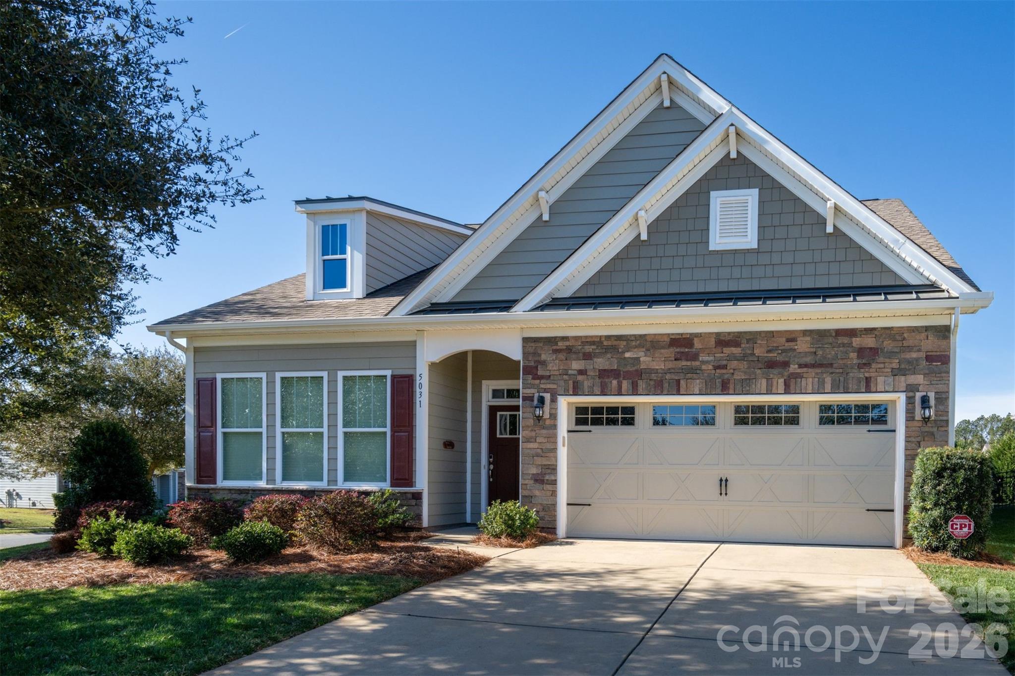 BUYER INCENTIVE:  $5K in closing costs or buy down your interest rate - your choice; paid by seller for a closing by July 31st.  Welcome to a stress-free lifestyle where your HOA dues cover Spectrum internet, cable, lawn & landscape maintenance (on your lot) and exceptional resort style amenities in a lakefront community.  This ranch style home on a premier end lot has been meticulously maintained and is move-in ready with fresh Agreeable Gray paint throughout. The home features a popular open floor plan with 10-foot ceilings, gorgeous hardwoods, and easy main-level living. The gourmet kitchen is a chef's dream, with a huge 11-foot island, gas cooktop, double ovens, and 2024 Bosch dishwasher and refrigerator. Relax in the main-level primary suite with its custom walk-in closet, or host guests in the private upper-level with bedroom, full bath and a loft area. Outdoors, enjoy beautiful landscaping with a brick paver patio, built-in fire pit and remote-controlled retractable awning. The community offers unmatched amenities, including walking trails, lake access, a boat launch, two pools, pickleball, tennis, dog park, and a brand-new clubhouse.  Boat, RV and Kayak storage on premise (check with HOA for availability).