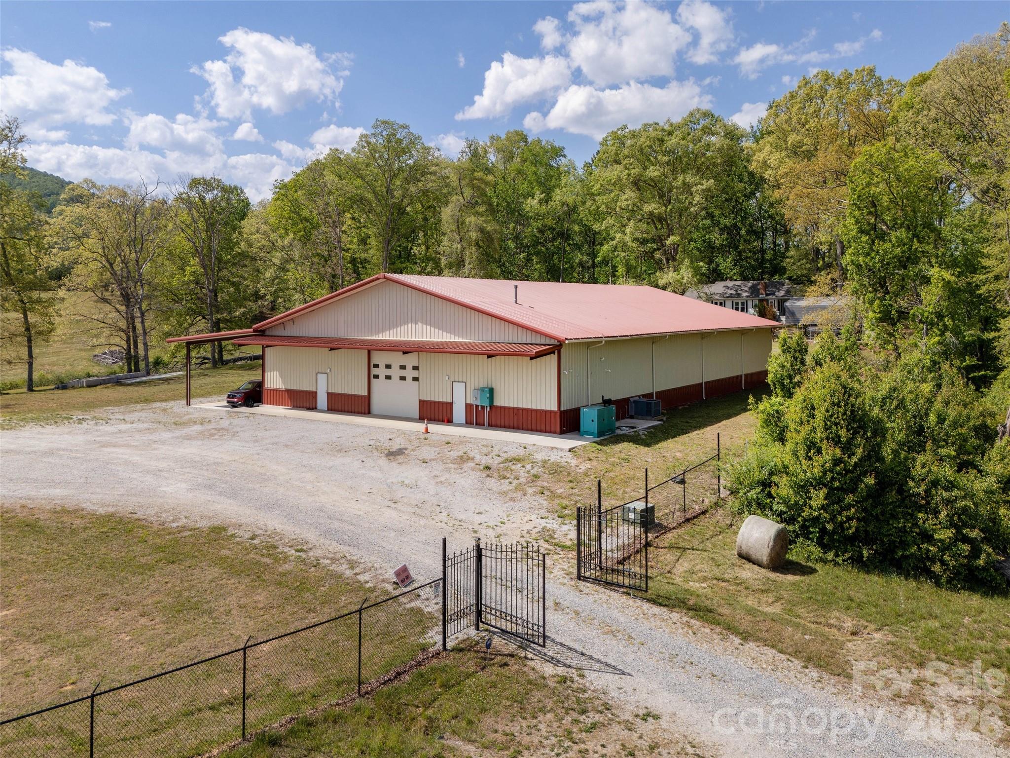 Discover an extraordinary mixed-use commercial property offering unmatched expansion potential for commercial use, eventing, or lifestyle development. This property is one of four tracts that combine natural beauty with strategic flexibility, making it ideal for users, investors, developers, or those seeking a private commercial or multi-purpose retreat. Building improvements on this 12.29 acre "portion of a much larger 40.69 acre site" include a 9,600 sf (clear-span) warehouse equipped with hydronic slab heat, air conditioning / suspended heat, generator and a detached 2,160 sf Morton barn. Subject to seller (timing) discretion, this property is offered individually as a stand-alone commercial property or, collectively with the whole 40.69 acres.  Transformation of the warehouse into an event center, restaurant with dance hall, production/showroom, recreational space or dynamic learning facility would fit well with the surrounding landscape (subject to buyer confirm of any contemplated land use in light of the Town of Mills Rivers' potential adoption of a UDO). 

This 12.29 acre portion of the larger estate offers sweeping views of lush rolling pasture and distant mountain views while the remainder land is rich in natural beauty and offers significant open space for expansion under a wide range of mixed-use possibilities including boutique commercial spaces, an event venue, or a thoughtfully planned, well segmented mixed-use community! Adjacent tracts include those outlined on the attached Pricing Exhibit.  

You be the visionary! Combine or re-segment the land to achieve maximum utilization, enhance circulation and development flexibility! With multiple points of public and private access, western portions of the property are well-positioned for large estate residential development while eastern portions lay out well for production or a myriad of adaptive commercial or mixed use reuse. Intuitively, the western ~23 acres borders the established Mill Ridge subdivision, reinforcing its viability for residential expansion. Just minutes from the Asheville Regional Airport, blocks from the new Publix shopping center, and ¼ mile from Mills River retail and employment centers, this truly one-of-a-kind property offers a rare blend of scale, flexibility, and location! Whether you choose to utilize, expand, or reimagine this property, have confidence knowing a property of this caliber is rarely offered!