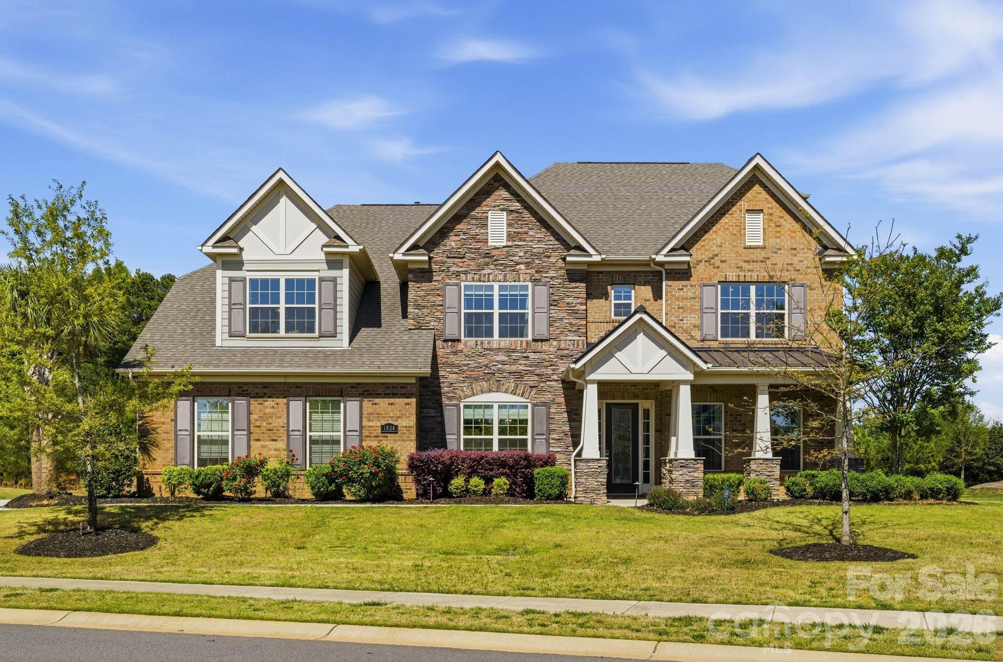 Situated in the desirable Weddington area, this former model home showcases a seamless blend of thoughtful design, quality craftsmanship, and modern comfort. From its impressive curb appeal and side-load three-car garage to the level backyard, with views of the woods this home offers both presence and privacy.
A welcoming foyer with 10-foot ceilings, engineered hardwood flooring, and detailed millwork leads to well-appointed formal living and dining spaces, as well as a spacious great room featuring coffered ceilings and a gas fireplace. The kitchen is designed for both functionality and entertaining, complete with an oversized island, quartz countertops, stainless steel appliances, farmhouse sink, walk-in pantry, and custom cabinetry. The adjacent covered patio and firepit create an easy transition to outdoor living.
The main level includes a desirable guest suite with a full bath. Upstairs, the primary suite offers a private retreat with a sitting area, balcony access, dual walk-in closets, direct laundry access, and a well-appointed bath. Secondary bedrooms are generously sized, each with its own en-suite bath. A flex space room could be a space for crafts or another office.  A bonus/media room with custom finishes and surround sound, along with a third-floor flex space, provide additional versatility for a variety of needs.
Additional features include a finished garage, irrigation system, and numerous designer upgrades throughout. Conveniently located near Waverly, Rea Farms, and Blakeney, with access to local amenities including fitness centers and recreational facilities. The expansive lot offers potential for a future pool or outdoor living expansion. Award winning schools.