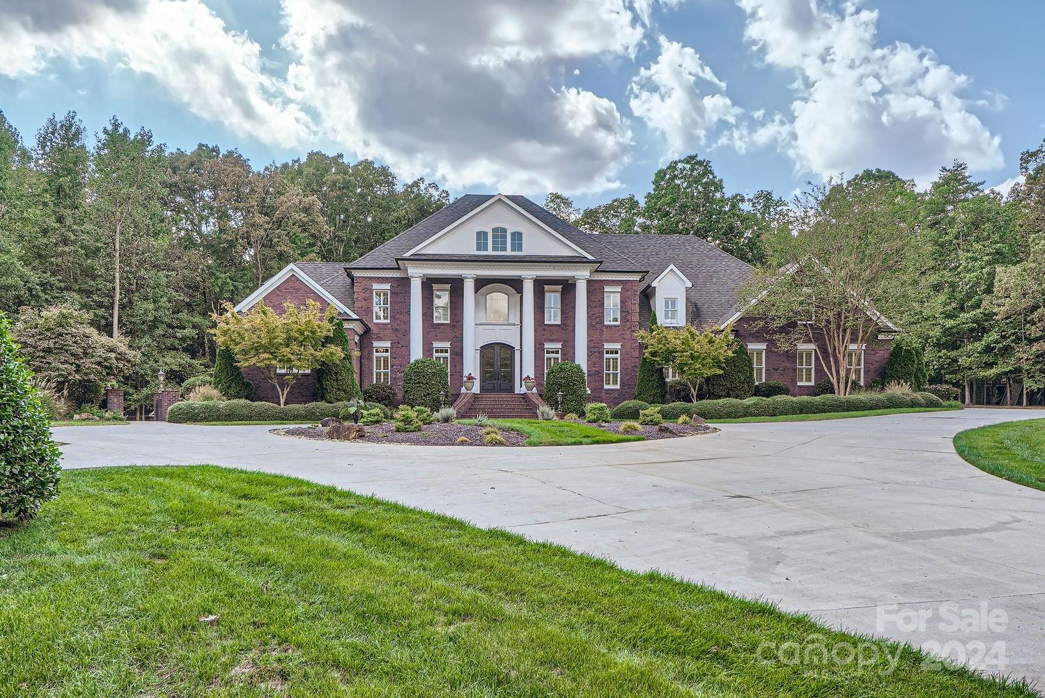 Discover this stunning gated estate conveniently located off I-485,4 BDRs, 4 full & 2 half BA on 6.88-acre fenced lot. The home boasts top-tier appliances, including a Sub-Zero refrigerator & freezer, a Wolf gas stove with a griddle, dual dishwashers, & double ovens. The luxurious primary suite on the first floor includes a spa tub, separate shower, dual sinks with a vanity, & two walk-in closets with custom shelving, plus a large seating area w/beautiful views. Enjoy 10-ft & 9-ft ceilings, elegant crown & base moldings, Marvin Ultimate windows, foam insulation, & durable PVC trim. Estate features the ERV HVAC system, attached 4-bay garage, and a 2-bay garage, a whole-house sound system, & security cameras. Outdoor amenities include a 6-ft perimeter fence, a newly installed gate operator, a travertine deck around saltwater pool, an onsite whole house generator & a well for irrigation. A large playground & an 8-ft-wide concrete trail through the woods complete this exceptional property.
