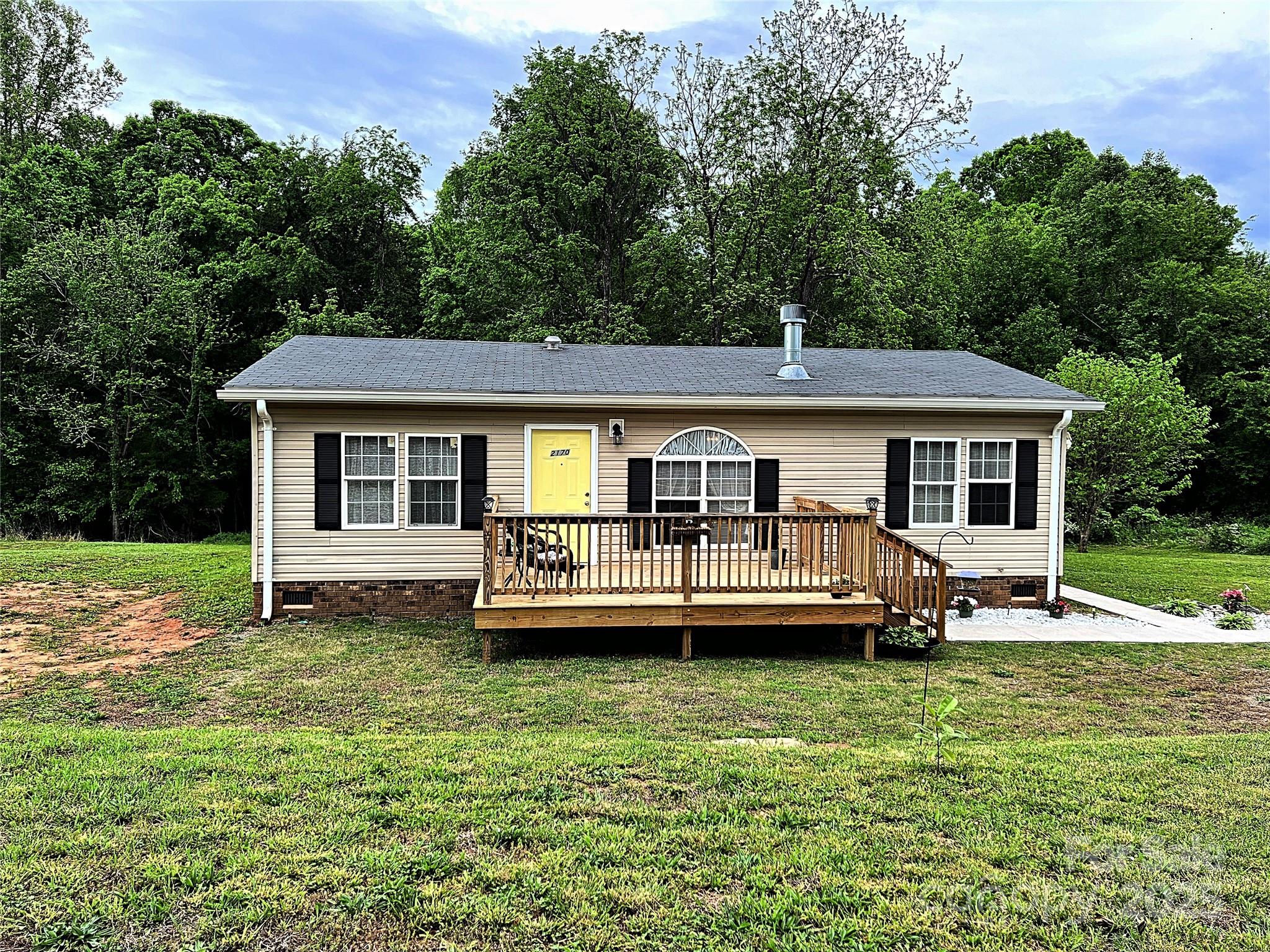 Charming, well-maintained, and exceptionally clean, this beautifully updated 3-bedroom, 2-bath home offers the perfect blend of cozy comfort and modern style. Built in 2013 and meticulously cared for, it features thoughtful updates throughout. The open layout boasts a sleek kitchen with a penny tile backsplash, updated fixtures, and all appliances—including a washer and dryer—just over a year old. A stunning wood-burning fireplace serves as the focal point of the inviting living room. The primary suite is a peaceful retreat with a walk-in shower, while two additional bedrooms provide flexible space for guests, a home office, or hobbies. Luxury vinyl plank flooring adds warmth and durability. Enjoy a private backyard, paved sidewalks, and a serene country setting just minutes from town. Fresh, stylish, and truly move-in ready—this home is a must-see!
