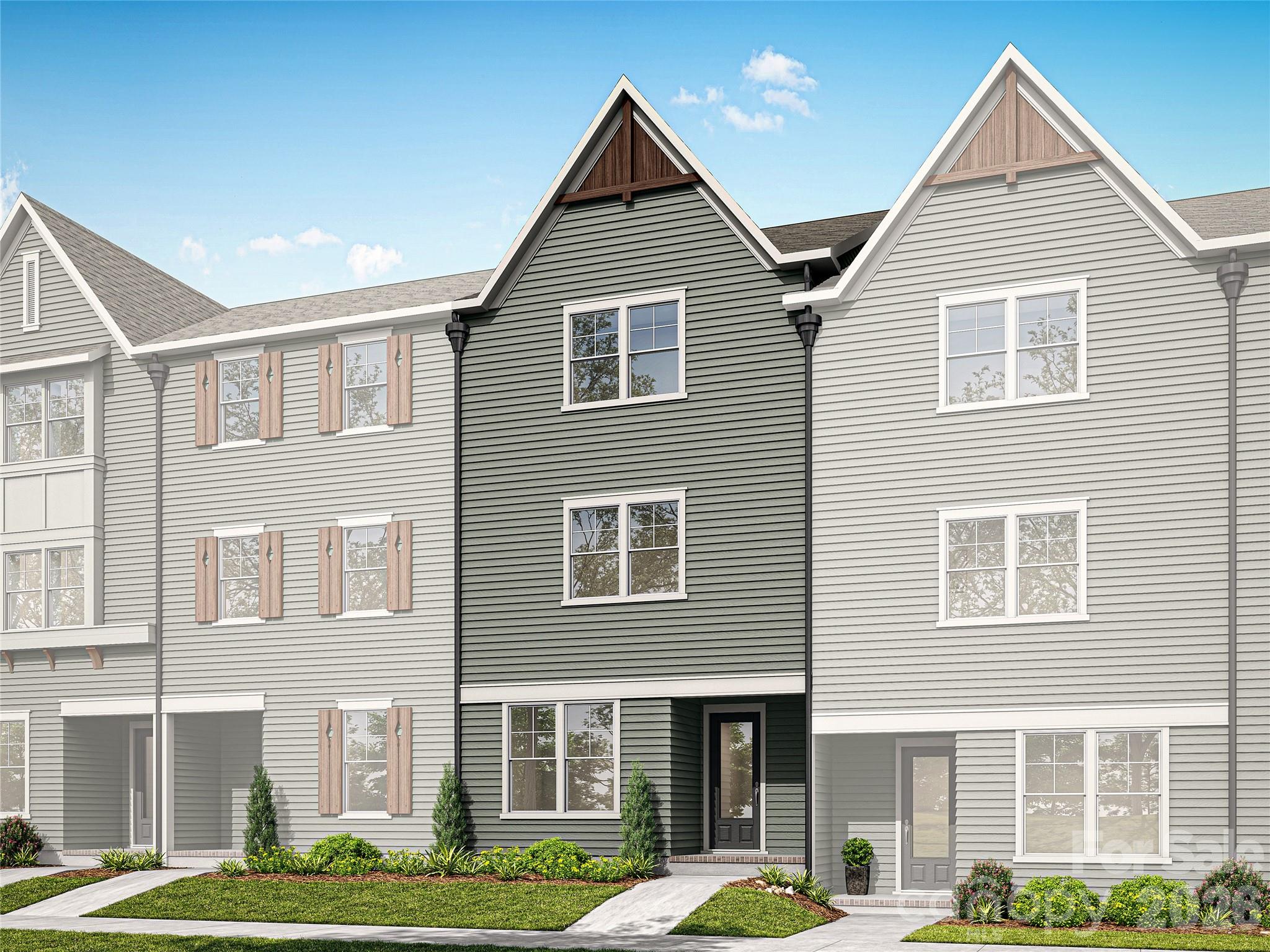 NEW CONSTRUCTION in East Charlotte - Townhome is located in the middle of this six-unit craftsman style building and features the Standard Transitional Design Package. The lower level offers one guest suite with a private bath - walk in shower with ceramic tile walls and floor. The common area is located on the main level and provides an open concept design with family room, dining area and kitchen with quartz counter tops, under cabinet lighting and center island with single bowl stainless kitchen sink. Electric fireplace in the family room with vertical shiplap backing. Luxury vinyl plank flooring in all common areas.    Carpet in all bedrooms, stairs & upper hallway. Primary bedroom suite located on the third level. Bath includes a double sink quartz vanity, oversized tiled shower and huge walk-in closet.  Third level guest suite has full bath with tub/shower combo and ceramic tile walls/flooring. Laundry room with cabinets located on the third level conveniently positioned near the primary bedroom and guest suite. Generously sized screened rear porch on the main level for ultimate privacy and relaxation on warm evenings. Two-car attached drive-under garage with opener, 2 remotes & electric car charger-prewire included - located on the lower level.