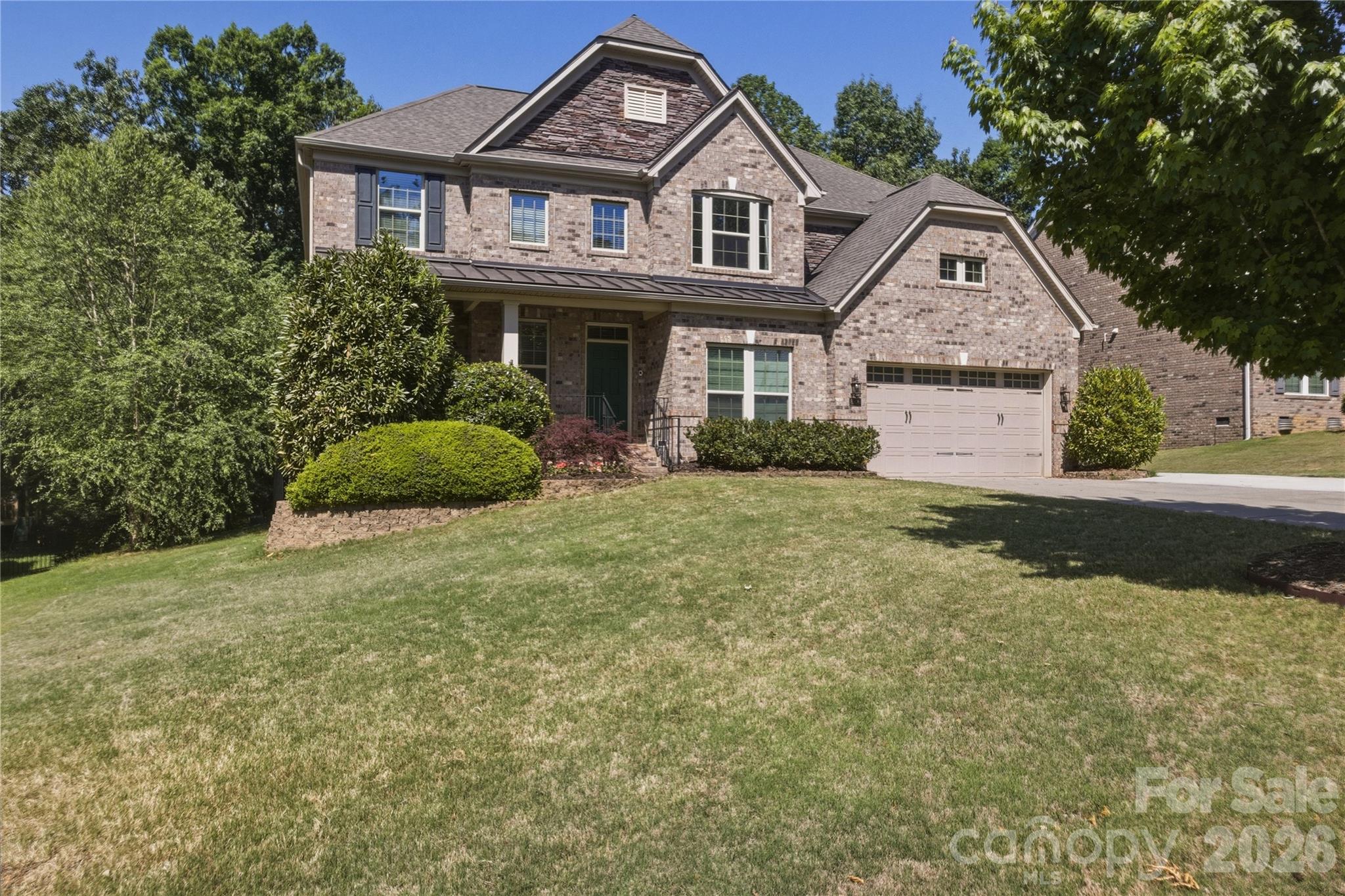 Beautifully maintained full-brick home offering timeless style, generous living spaces, and a thoughtfully designed layout in a peaceful, tree-lined setting. From the moment you arrive, the home's curb appeal, manicured landscaping, and welcoming covered entry create a warm first impression.

Inside, you'll find elegant details throughout including hardwood floors, extensive trim work, coffered ceilings, tray ceilings, archways, and wrought iron staircase balusters that add character and sophistication. The formal dining room features classic wainscoting and abundant natural light, creating the perfect space for hosting gatherings and holiday dinners.

The heart of the home is the spacious open-concept kitchen and living area designed for both everyday comfort and entertaining. The gourmet kitchen features rich cabinetry, granite countertops, stainless steel appliances, a built-in double oven, gas cooktop, oversized center island, with seating, and a bright breakfast are overlooking the backyard. The adjoining living room is filled with natural light from oversized windows, hardwood floors, and plenty of room, creating an inviting atmosphere throughout the main level.

Upstairs, the spacious primary suite offers a relaxing retreat complete with elegant tray ceilings, large windows, dual walk-in closets, and a luxurious ensuite bath featuring dual granite vanities, a tiled walk-in shower with glass enclosure, and a garden tub. Secondary bedrooms are generously sized, including convenient Jack-and-Jill bathroom access with dual vanities and a separate private tub and toilet area designed for functionality and privacy.

The finished bonus room over the garage provides exceptional flexibility and can easily function as a media room, playroom, fitness space, home office, or additional living area depending on your needs. 

Step outside to enjoy the low-maintenance composite deck, ideal for grilling, outdoor dining, or simply relaxing while overlooking the private backyard. Mature landscaping and a wooded backdrop create a peaceful outdoor setting with space to entertain, play, or unwind.

Additional highlights include:
-A spacious two-car garage with extra workshop and storage space 
-Abundant natural light throughout the home
_A floor plan that blends elegance with everyday practicality
-Refreshed paint in common areas
-Full brick with professionally installed hardscaping in the backyard
-New (2024) composite deck with gas hook-up and lower level deck expansion
-Expanded driveway
-Beautiful community with wooded walking paths, community pond, and a convenient location to neighborhood amenities. 

This home offers the perfect balance of comfort, functionality, and classic design in a beautiful setting.