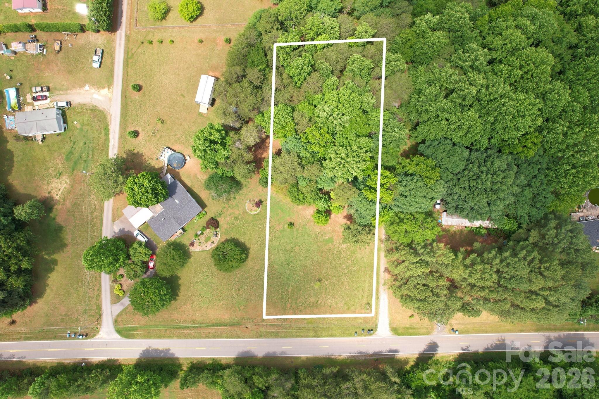 Rare opportunity to build on a level 1.01-acre homesite near Lake Norman. This partially cleared lot features a small wooded area for added privacy and already has a septic permit approved for a 3-bedroom home. Approximately 0.92 acres are outside the road right-of-way (see survey). Well required. No HOA. Neighboring septic easement affects a small area near the front left corner of the property (see septic plat). Enjoy the best of both worlds—a peaceful rural setting with convenient access to Sherrills Ford's growing collection of shopping, dining, and services, including Publix, Chick-fil-A, Wendy's, and more. Bring your builder and start planning your future home.