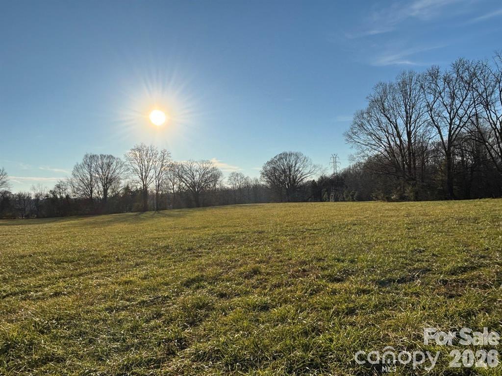 ACREAGE!! FARMLAND , EST 9.80 beautiful open pasture, great for raising animal, gardening, or building your dream home. This is a one of a kind property! Conveniently located to a grocery store, restaurants, salons, and more. Beautiful pasture land with gorgeous sunsets! The property has an old homeplace on it with a septic .  A large shed with a lean-to and a tractor  shed  are located on the property. There are 4 parcels included with this listing, Lot 2-5, which connects to Skyland Dr. There is also a 3 bedroom, 2 bath home on an additional parcel, which is  MLS 4324519.