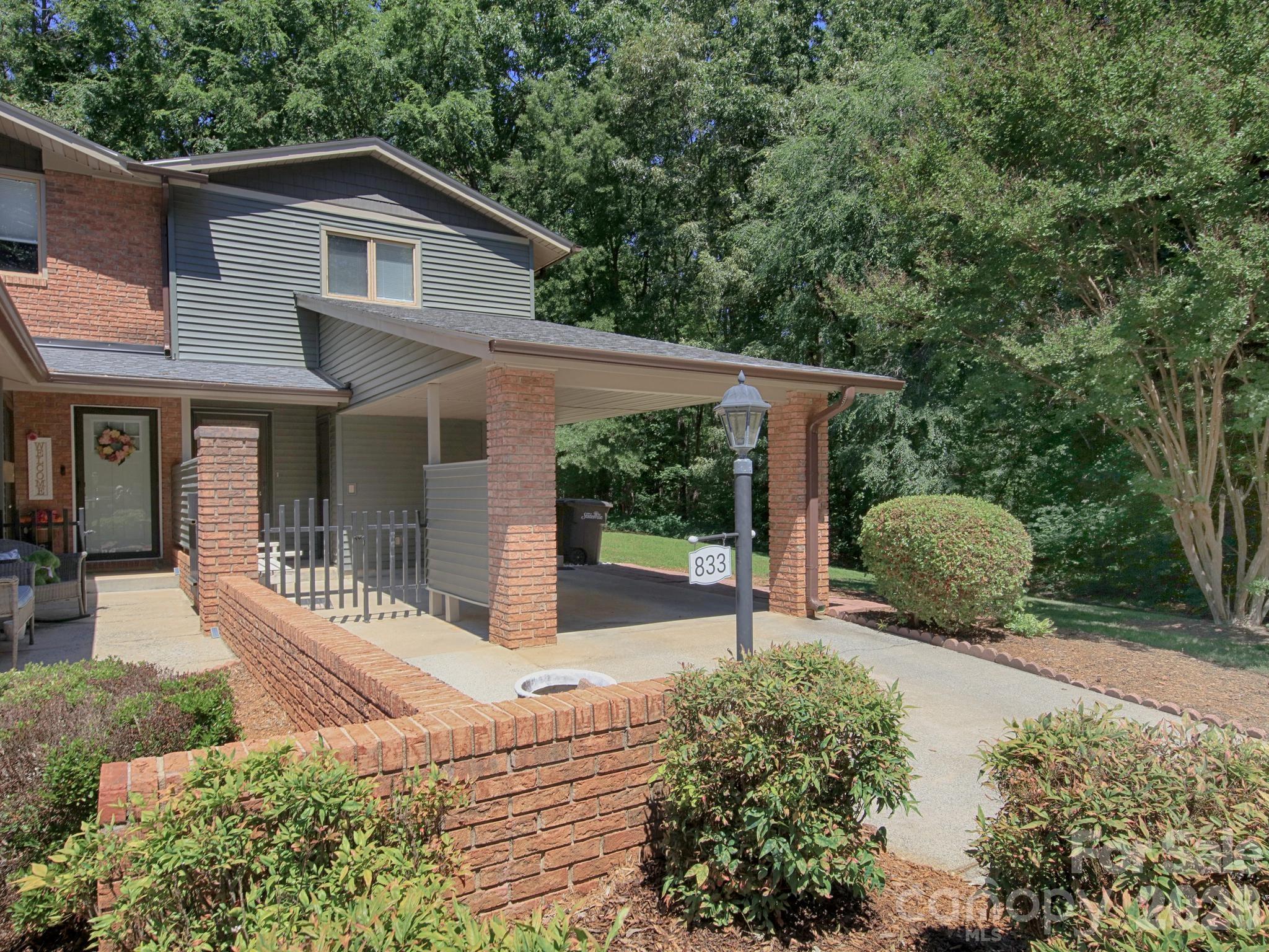 Welcome to this well-maintained 2-bedroom, 2.5-bath end-unit condo located in the desirable Berkshire's Mark community. Enjoy easy access to I-77 while living in a small neighborhood with a peaceful setting and low-maintenance lifestyle. The main level features an open floor plan designed for comfortable everyday living and entertaining. The spacious living and dining areas flow seamlessly into the kitchen, which is equipped with stainless steel appliances and ample cabinet space. New vinyl plank flooring on the first floor. A convenient half bath is also located on the main level for guests. Upstairs, you'll find two bedrooms with two full baths. The primary bedroom offers attractive, spacious built-in dressers and cabinetry, providing excellent storage and organization while maximizing space and functionality. An upstairs utility room adds everyday convenience by keeping laundry close to the bedroom level. Step outside to the private rear brick patio, perfect for morning coffee, outdoor dining, or relaxing after a long day while enjoying the privacy of an end unit. Additional features include an attached one-car carport and a dedicated storage room off the carport, offering ample space for seasonal items, tools, and extra belongings. Located in a quiet, well-established community, this condo combines comfort, convenience, and low-maintenance living. Close to shopping, dining, and major transportation routes, 833 Coventry Lane is an excellent opportunity for first-time buyers, downsizers, or anyone seeking the easy-care lifestyle of condo living in a great location. Don't miss your chance to make this charming Berkshire's Mark condo your new home—schedule your private showing today!