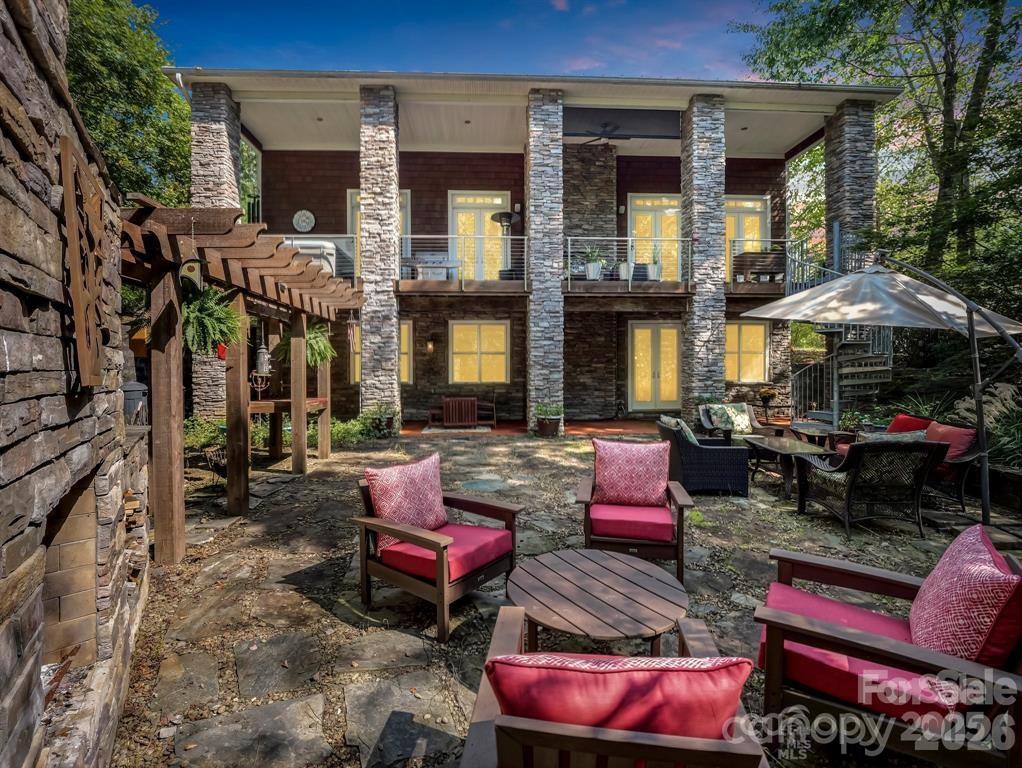 Lake Lure has risen and back to its natural beauty! Now is the time to take advantage of this huge price reduction! Sellers had to move on from this superior custom built home. The peace & tranquility this home offers is abundant with its end of cul-de-sac location, walking trails, fish pond (awaiting for some occupants) and abundance of nature.  This one-of-a-kind cedar shake & stone home has a very open 2-story concept w/lots of natural light & unique appeal thru-out.  The stunning main level has maple HWD floors, high-end 'Monogram' appliances, granite countertops, cherry cabinets & a KIT island that makes way for a chef's dream. GR has see-thru gas FP to exterior that has 'Eon' decking (lifetime warranty) a hot tub & great view of outdoor entertaining area. The main level primary en-suite has soaring 18'+ vaulted ceiling, 2 walk-in closets, tile shower & convenient laundry room. Gorgeous wood steps lead to the 2nd level, or take the 3-story elevator. Up there you'll find an open concept loft w/numerous options and a private 'link' to a full bath & guest suite. Wind down in the evening in the walk-out basement with an entertaining bar, a cozy FP & all around great flex space to suite your style. Outside you'll find your private oasis w/2 fireplaces & established landscaping & gardens that needs a new owners TLC or let it return to nature and be low maintenance - it's all in your heart's desire. All this on 2 private acres in a small gated community.  Top all this off with a whole house generator that keeps the household humming and an oversized dbl garage that has a heated & cooled workshop. Lots of house and property at this price. Must see to appreciate!