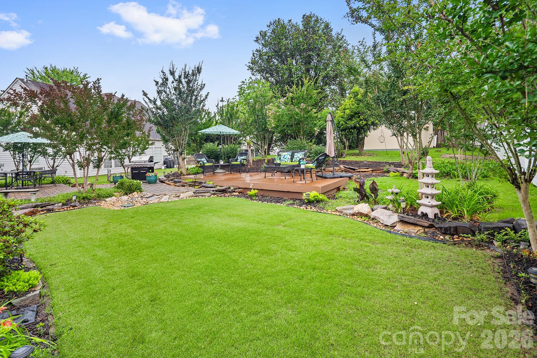 Meticulously maintained home just minutes from charming downtown Waxhaw featuring restaurants, boutiques, and local shops, all within a community zoned for award-winning schools. Enjoy outdoor living in the private, professionally landscaped backyard oasis complete with mature trees, spacious patio with composite material, and multiple seating areas. Three Year Old 10x12 Shed would make a good He/She Shed or a playhouse. This beautiful open floor plan offers gleaming hardwood floors, upgraded lighting, elegant black iron stair spindles, and abundant natural light throughout. The formal dining room showcases a tray ceiling, while the gourmet kitchen features granite countertops, tile backsplash, gas range, and newer stainless-steel appliances. The spacious main-level primary suite includes a whirlpool tub, quartz dual vanity, and separate shower with new glass enclosure. Upstairs offers three generously sized bedrooms, including an oversized room perfect for a bonus space or home office, plus convenient walk-in attic storage.  Plenty of backyard space to build a pool if desired.