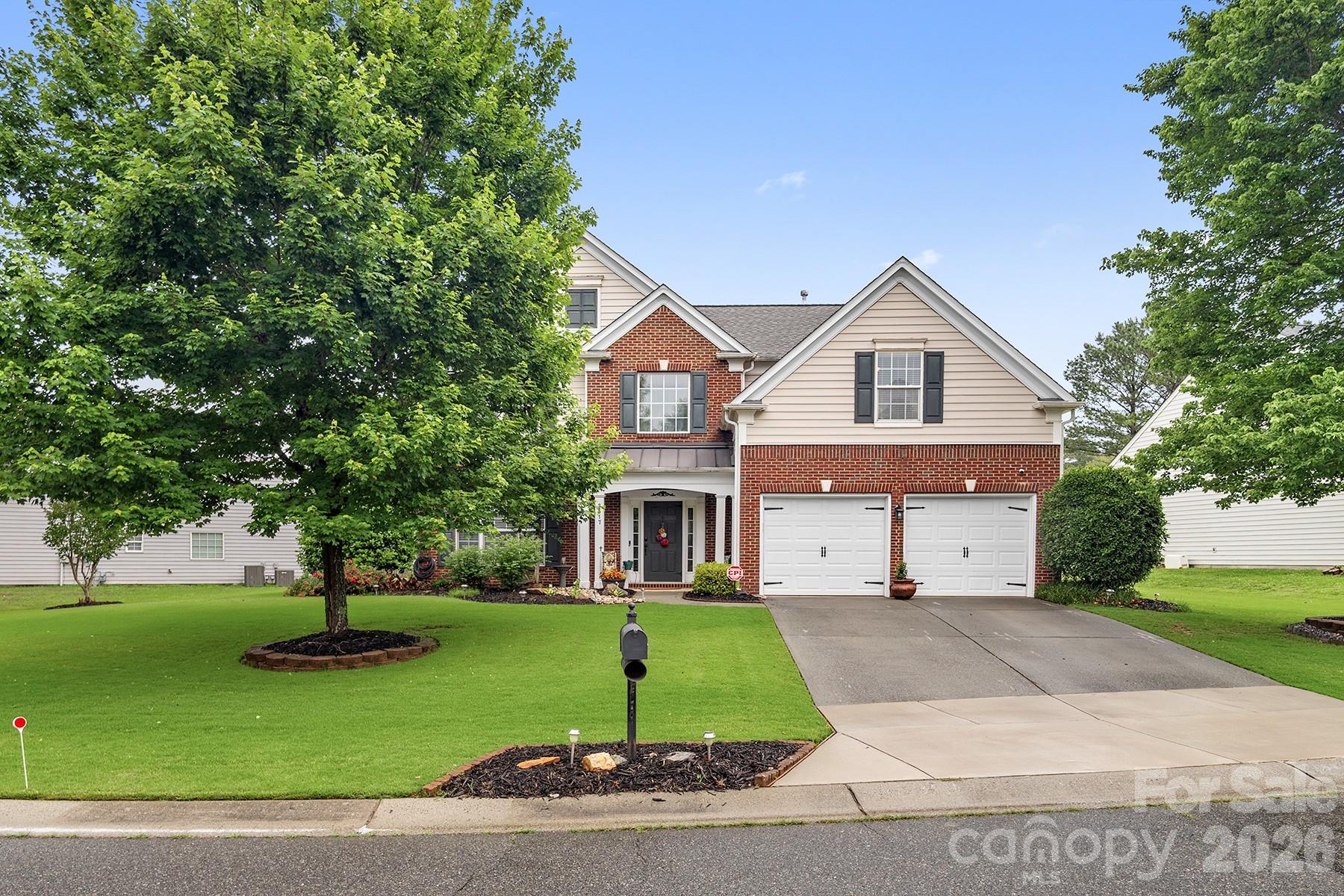 Enjoy outdoor living in the private, professionally landscaped backyard oasis complete with mature trees, spacious patio, and multiple seating areas. Meticulously maintained home just minutes from charming downtown Waxhaw featuring restaurants, boutiques, and local shops, all within a community zoned for award-winning schools. This beautiful open floor plan offers gleaming hardwood floors, upgraded lighting, elegant black iron stair spindles, and abundant natural light throughout. The formal dining room showcases a tray ceiling, while the gourmet kitchen features granite countertops, tile backsplash, gas range, and newer stainless-steel appliances. The spacious main-level primary suite includes a whirlpool tub, quartz dual vanity, and separate shower with new glass enclosure. Upstairs offers three generously sized bedrooms, including an oversized room perfect for a bonus space or home office, plus convenient walk-in attic storage.  Beautifully updated and move-in ready inside and out!