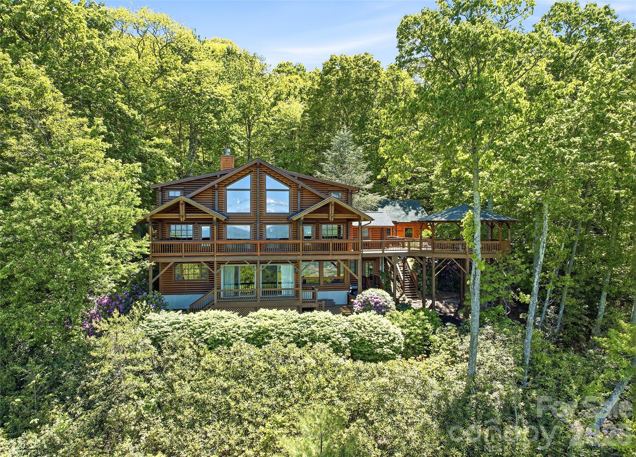 Excellent long range views of Jonathan Valley and the surrounding mountains are showcased by the wall of windows in the Great Room of this authentic Honka log home. The well designed home compliments the natural setting. The home features a stone, wood burning fireplace. vaulted ceilings, exterior living area and pavilion to enjoy the cool summer weather. Chef's kitchen with 6 burner Viking, Sub-Zero and Miele appliances. Newly built garage is set up for a wood working space with plenty of room and a level driveway. Located in the gated community of Smoky Mountain Retreat at Eagle's Nest. Furniture and accessories are included with some exceptions.
Heat Pump Replaced 2023, House painted 2023, deck stained 2023, Roof replaced 2024.