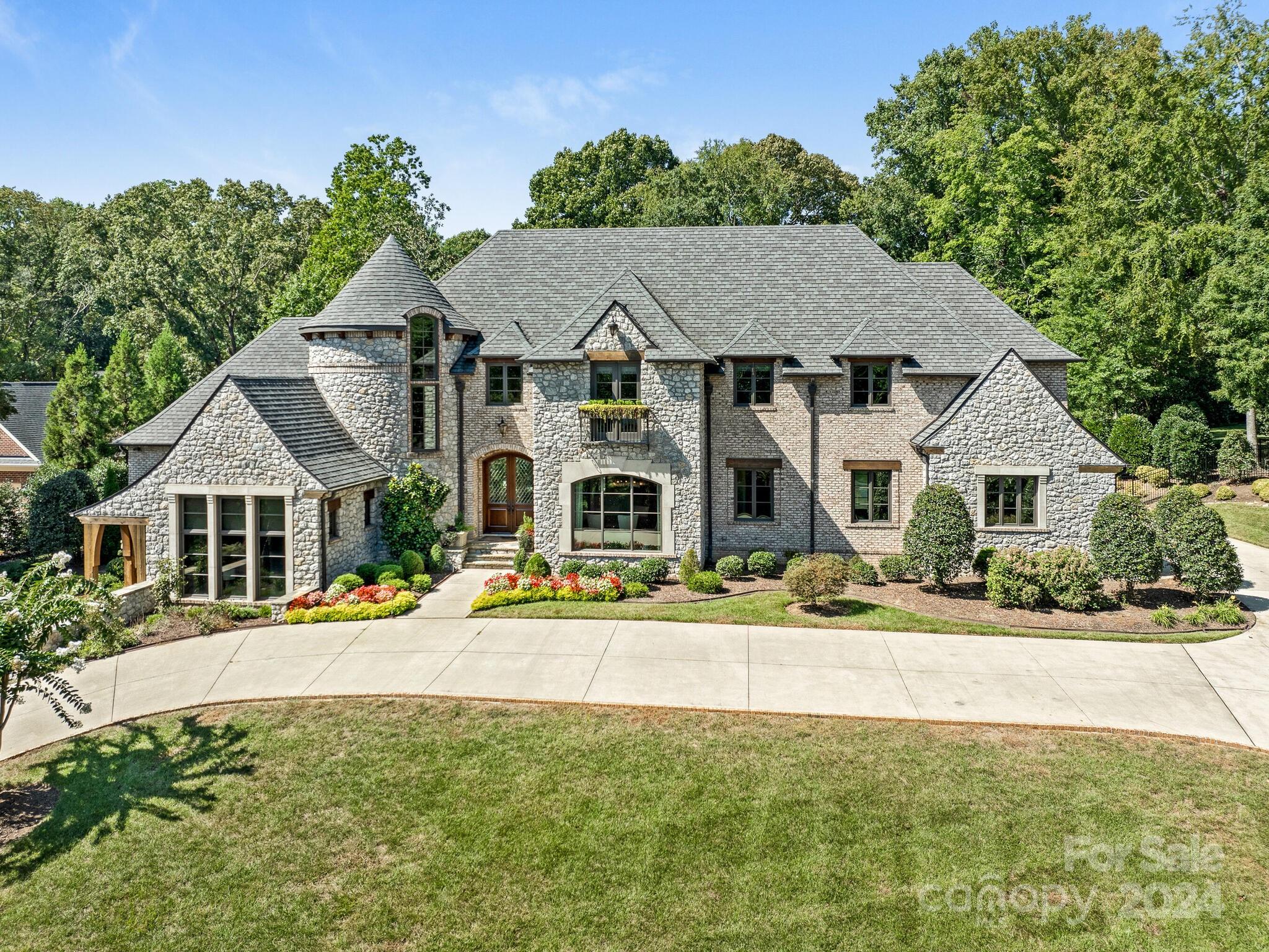 Luxury Living in the heart of SouthPark, welcome to 5201 Carmel Park Drive. This stunning home boasts 5 bedrooms and 5.5 bathrooms within its expansive living space, all nestled on a sprawling 1.37 acre very private lot. 
Discover a wealth of amenities, including a heated salt water pool, a private outdoor space perfect for entertaining, built-in grill and a charming covered patio with fireplace for moments of relaxation.
The interior is equally impressive, featuring a two story Family Room with architectural details, Custom Cabinetry, a beautiful kitchen, Dining Room with exquisite lighting and a gorgeous spiral staircase. Upstairs you will find additional bedroom en-suites, as well as a large Recreation Room complete with bar and kitchenette.
The Main Level Owners Retreat features an en-suite bathroom with heated tile and private laundry, as well as a separate Study/Guest Suite on the lower level.
Don't miss the opportunity to call this magnificent property home.