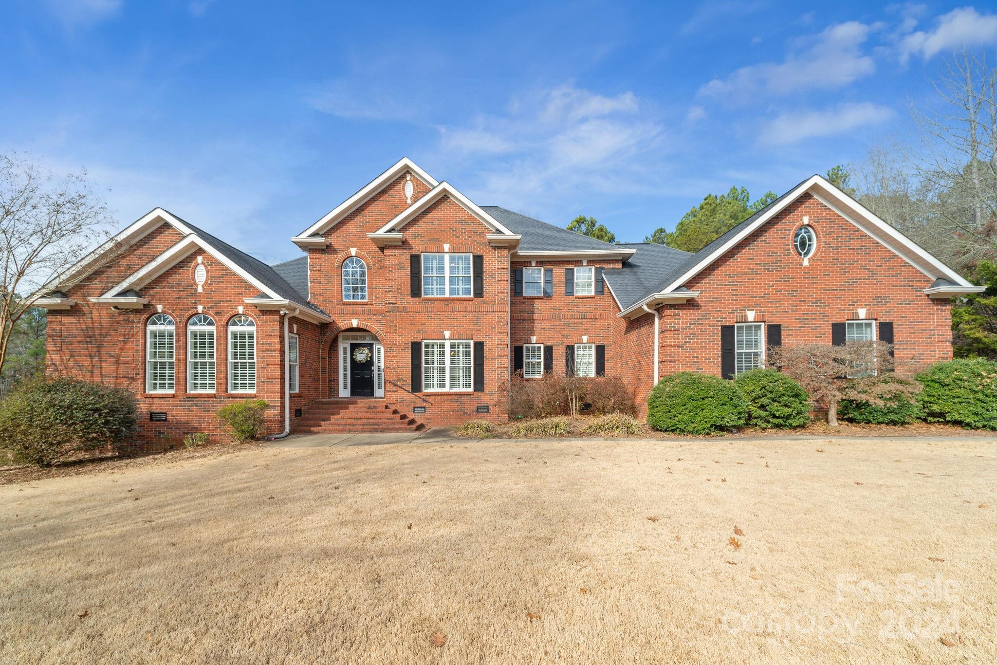 Stunning all-brick home on sprawling 1-acre lot in Fort Mill's desirable Huntington Farms. Perfectly located in a quiet cul-de-sac, backing to woods. The primary suite on main level overlooks the backyard and has tray ceiling, cozy fireplace and leads into the spacious bath featuring a spacious tile shower, garden tub, and two walk-in closets.  Dual staircases lead upstairs to 3 additional bedrooms and a generously sized double bonus room which can be used for another bedroom, game room, theater room, etc. Beautiful covered patio overlooks the inground pool and private lot. Fully fenced rear yard with additional property beyond the fence. 3 car attached garage has a convenient bath for pool goers. Detached garage includes unheated bonus space above with so many potential uses. Upstairs HVAC  2023, kitchen cabinets professionally painted and upstairs shower in Jack and Jill bath was updated in 2021. Water purification system, tankless water heater, and incredible storage.