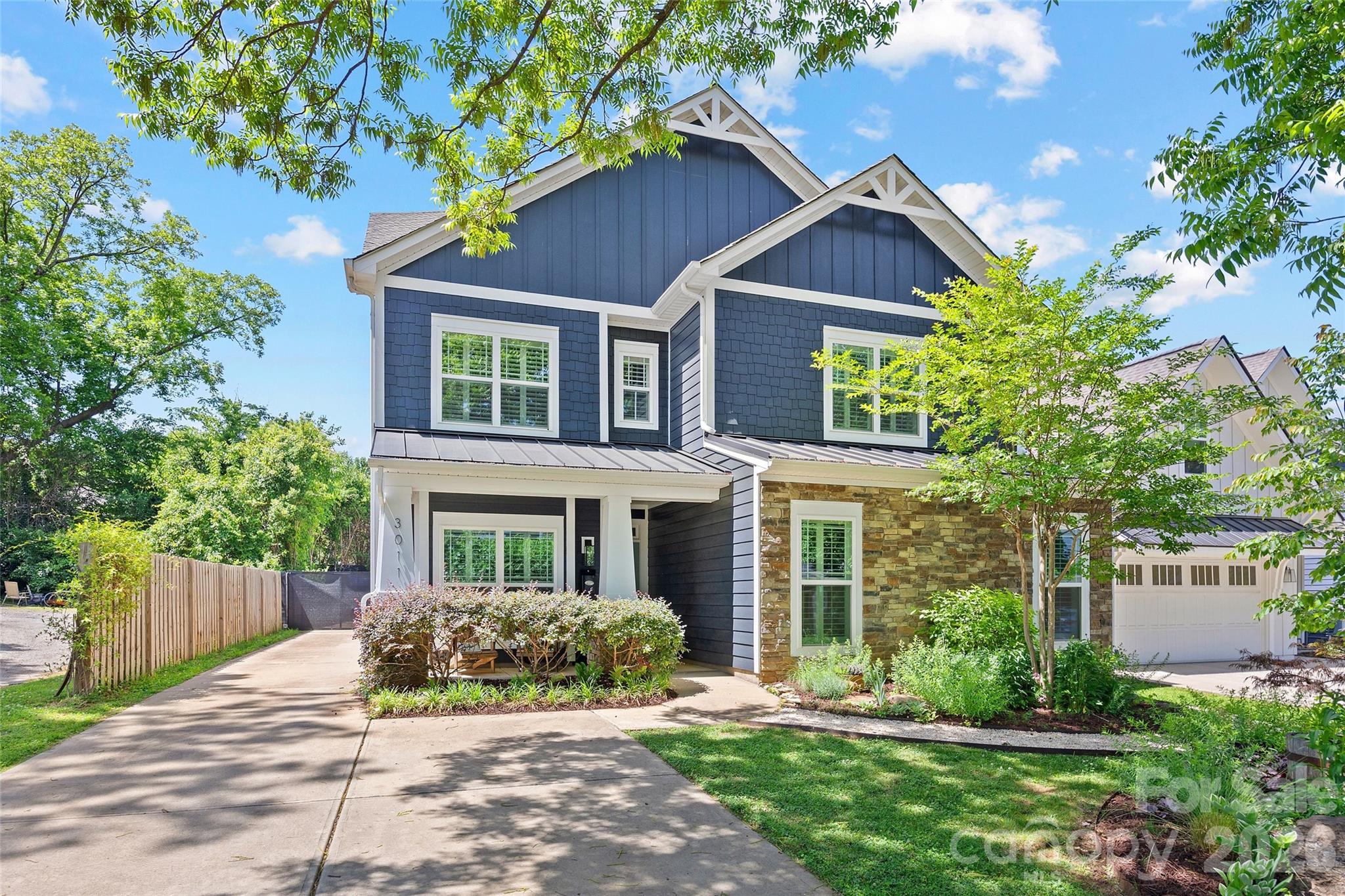 Welcome to this stunning 5 bed 4.5 bath home located in the heart of Charlotte’s highly sought-after Midwood neighborhood. This home balances modern luxury with everyday comfort, featuring an open floor plan. The welcoming entryway opens to the dining room, which leads to the spacious kitchen with white painted cabinetry, quartz countertops, and stainless steel appliances. An oversized center island provides the perfect spot for entertaining. The living room features a built-in bar and a cozy flex space, ideal for a reading corner or a breakfast room.  The main level offers a dedicated enclosed office and a guest suite or second primary bedroom with en suite bath. 
Upstairs, the primary suite serves as a private oasis, highlighted by a walk-in closet designed by California Closets in 2025. The spa-like primary bathroom features two vanities, a large soaking tub, and walk-in shower. Each of the secondary bedrooms is generously sized, and each bathroom is beautifully finished, ensuring comfort for family and guests alike. 
Outdoor living is a highlight of this property, providing multiple spaces to relax and entertain. Enjoy the fresh air from the three-season porch with room for lounging and dining, or enclose the porch with windows designed and installed by Valverax. Walk out to the spacious deck and the designated fire pit area. The backyard also features a greenhouse, raised garden bed, and storage shed. Low-maintenance native plant landscaping along with irrigation, makes yardwork a breeze.  The three-car garage, with storage area above, is a rare and valuable find equipped with a Tesla charging station. Home includes a tankless water heater and a whole water filtration system.  This home offers the perfect blend of sophisticated design and Midwood charm.