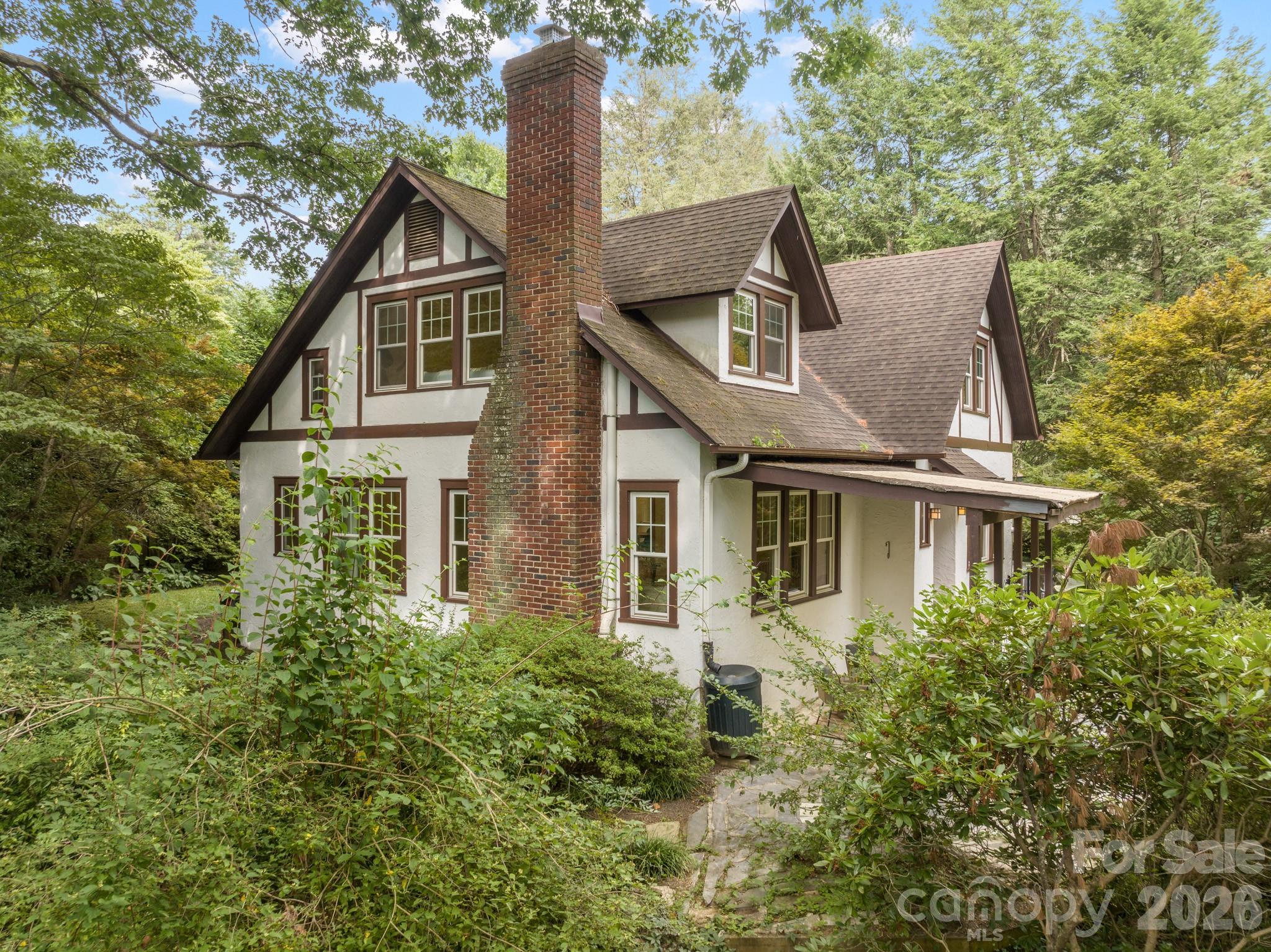Across from the Leah Chiles Park in Kenilworth, an unassuming entrance lined with Skip Laurels, opens up to a forested urban estate, a private forest of rare conifers from around the world, with a classic 1926 Tudor home and additional cottages designed in the same style and spa for guests. Cottage Corner, four dwellings in two abodes, mirror each other sharing a modern spa with organic cedar plank sauna and mandala brick courtyard, welcoming you to evening soirees, morning yoga and meditation. 1.38 acres of forested estate invite you to bathe in nature, rest & escape. Trails meander beneath towering evergreens with sunbeams that dance on the shaded forest floor. The main house maintains its historical charm with classic details. Large windows frame views like paintings of the magical outdoors from waking in bed or sitting in a comfy nook with a book. Find peace & tranquility for you and your guests in this hidden retreat in the middle of the city at 108 Lakewood. Also listed 4157016.