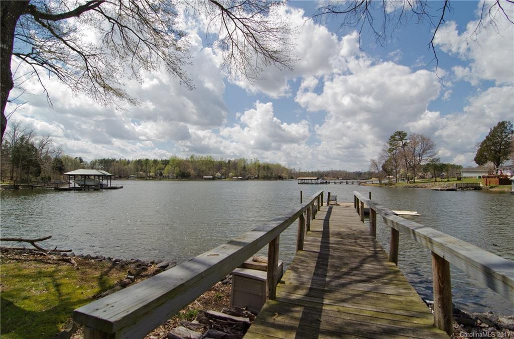 Awesome waterfront listing with 2 docks!!Unheard of in Lake Wylie and close to bridge for commuters. Huge rocking chair front porch to enjoy expansive views of Crowder's Creek. Open, comfy floorplan with one bedroom on main floor. Home features fenced yard, 2 sheds for many uses, 1+ acre lot, very private, & over 200 foot of water frontage. Come bring friends and all of your water toys!