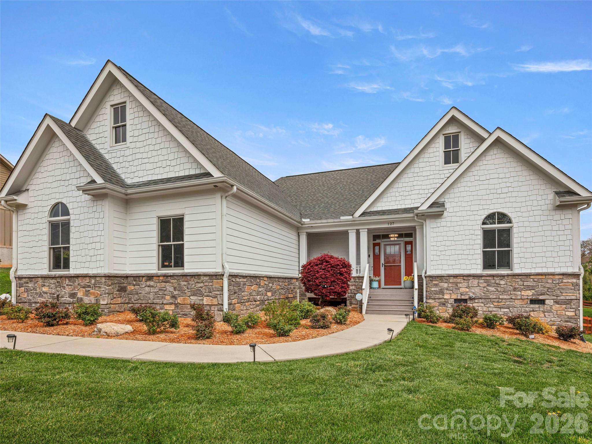 Welcome to this beautifully upgraded, single-level home in the highly sought-after Hollabrook Farm community of Mills River. Built in 2016 and thoughtfully modernized, this home combines timeless craftsmanship with fresh, designer-forward updates, all on a gorgeous corner lot. 

Inside, you'll find a spacious, open-concept floor plan with split bedrooms for added privacy, gorgeous light oak wood floors, vaulted ceilings with wood beams, and a chef's kitchen complete with a massive granite island and newly reconfigured layout for better flow and functionality. The home opens seamlessly to a beautiful great room and a screened-in porch overlooking a fully fenced, level backyard - perfect for entertaining or quiet evenings at home. 

Enjoy main-level living, a beautiful professionally landscaped yard, and a truly move-in ready space with no detail overlooked.