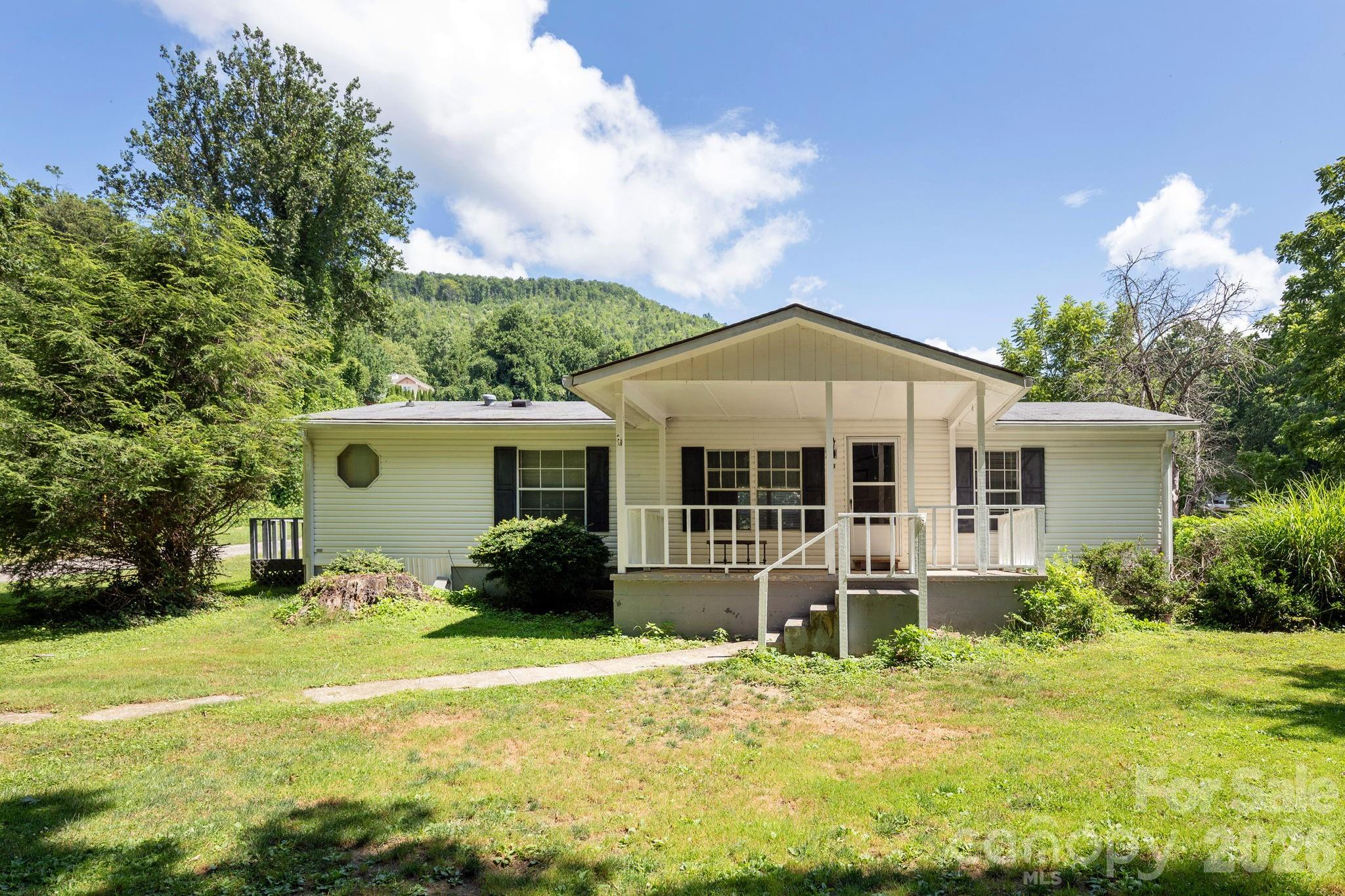 Charming 3BR/2BA mobile home situated on a level 0.5-acre lot in a peaceful Black Mountain neighborhood. Features include a cozy wood-burning fireplace, spacious living area, and a flat yard with plenty of room for outdoor enjoyment. Conveniently located just minutes from downtown Black Mountain, offering easy access to Ridgecrest, Asheville, and surrounding areas. A great opportunity for a primary residence or investment property.