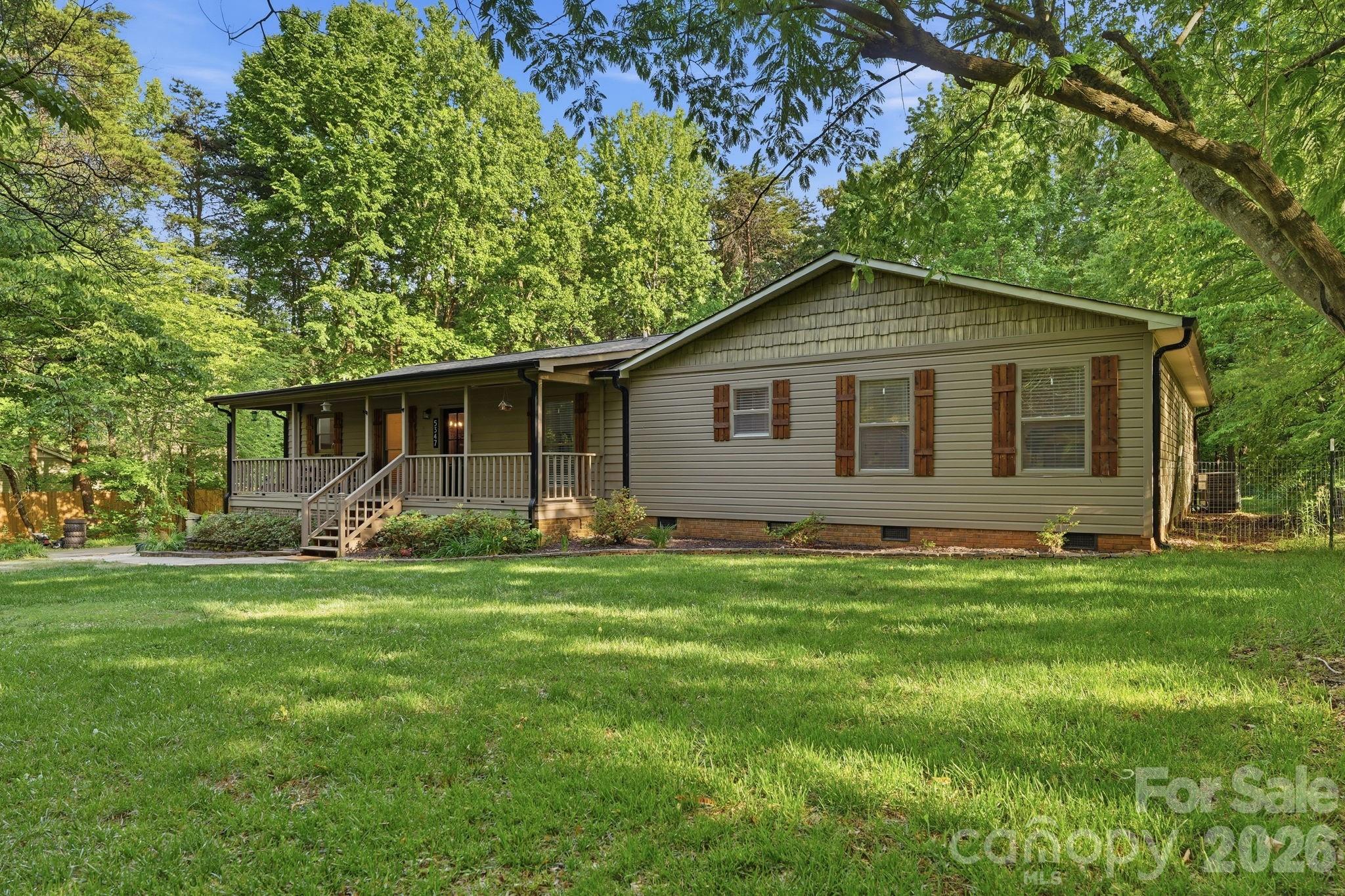 Set on 2.2 serene acres, this property delivers the homestead lifestyle so many dream of—space for chickens, gardens, and a life lived closer to the land, all just minutes from shopping, dining, and the waters of Lake Wylie. A full interior renovation brings modern comfort to the forefront, featuring a brand-new kitchen with all SS appliances, a whole-house water filtration system, and a wood-burning fireplace with a new damper that anchors the living space with rustic charm. The rocking-chair front porch invites slow mornings, while the back patio offers peaceful evenings overlooking your private acreage.  Park your RV or camper on the property will full electric hookups. Thoughtful upgrades include a fully encapsulated crawl space with a dehumidifier, NEW HVAC 2025, NEW roof installed 2021, a new long asphalt driveway is perfect for parking several vehicles, your boat and RV.  Well was serviced just last year with a new bladder tank and upgraded water pressure. Water is conveniently run to the chicken coop and garden area, making homesteading effortless. With 5 bedrooms plus an office off the mudroom, this home blends function and flexibility. Zoned for the new Lake Wylie High School and wrapped in quiet, natural beauty, this is a rare retreat where modern living and country serenity meet.  Best of all, no HOA!