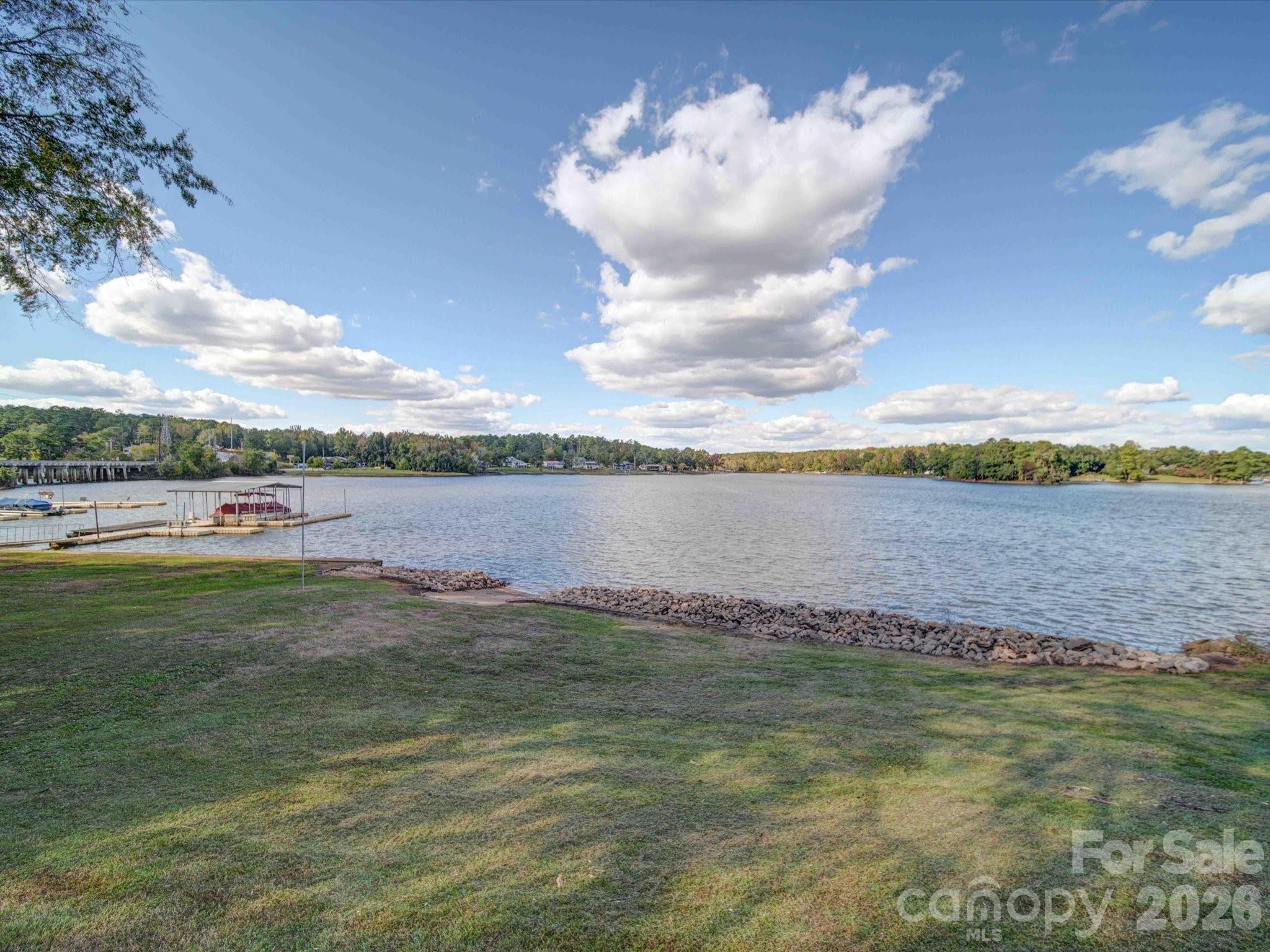 This stunning 3-bedroom, 2-bath home on Lake Wateree is a must-see! Located just a short walk from all three restaurants in Beaver Creek, it boasts luxury vinyl plank floors and an open floor plan that enhances the breathtaking lake views. The master bedroom features a private bath and direct access to deck, perfect for relaxing and enjoying sunsets. Additional highlights include private boat ramp, assigned detached garage, and garage door access to crawl space. Don’t miss this opportunity to live the lake life!