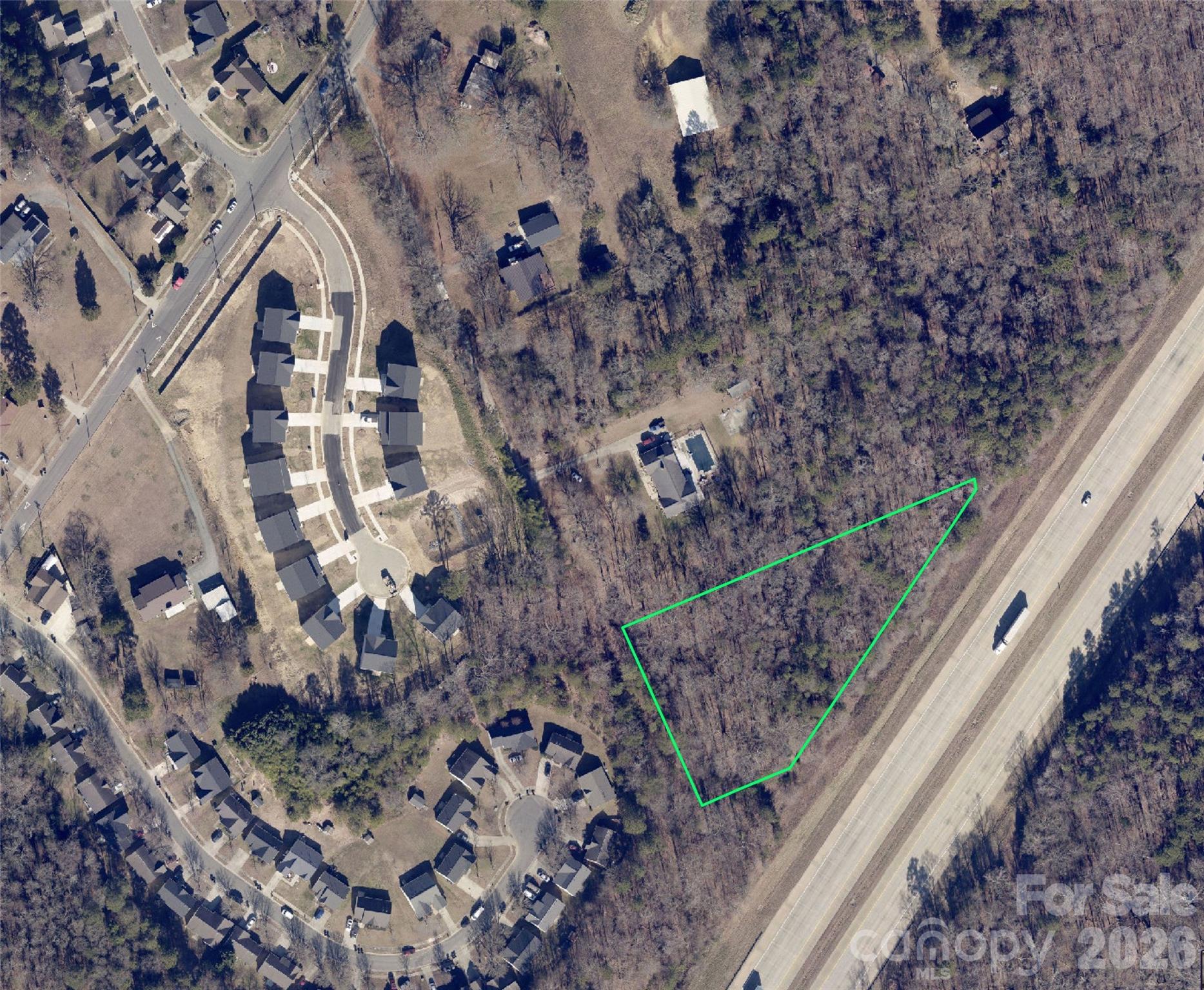 Unimproved land on 1.74 acres in the fast & growing zip code 28214, this property is tucked-away down a public gravel road, the lot offers privacy and backs up to I-485. Property is close to Whitewater Center, CLT Airport, shopping and quick  access to I-485 or Highway 16. Land passed soil test for septic system.