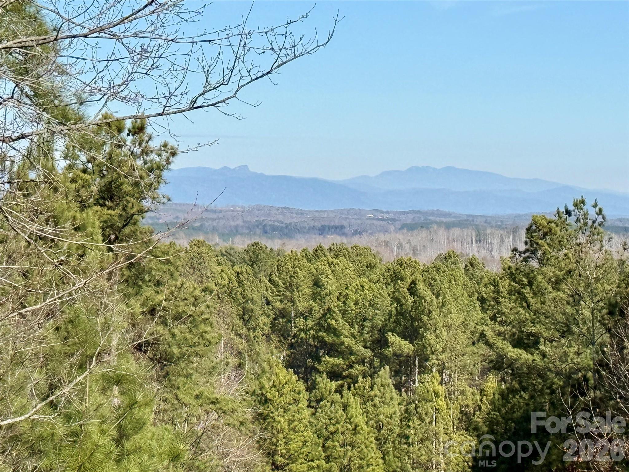 Peaceful mountain living begins here!  Don't miss this beautiful 1.3 acre mountain homesite with long-range mountain views, located is the much sought-after gated community of Grandview Peaks. This is the perfect setting for your dream mountain home or family retreat. The gently sloped land lends itself perfectly to a walkout basement and the extensive road frontage allows both upper and lower access. A custom home can be situated anywhere on this land, but is best utilized with the rear of the home facing the bold Blue Ridge Mountains. Enjoy views of Grandfather, Shortoff and Table Rock Mountains - Landmarks of western North Carolina! Enjoy nature at every turn in this 1600 acre mountain community with miles of community hiking trails and a community lake stocked with trout & small-mouth bass. Cookout with neighbors or join one of the many social clubs made up of the friendly neighbors who make Grandview Peaks such a special place to call home. There is no time-frame requirement to build, so you invest in your land now and build whenever you're ready. This property is located within walking distance to the community amenities and close to the gated entrance, allowing convenient access to the wonderful small towns just minutes away. Don't wait...make plans to come see this wonderful property and all the serenity that the NC Mountains offer!