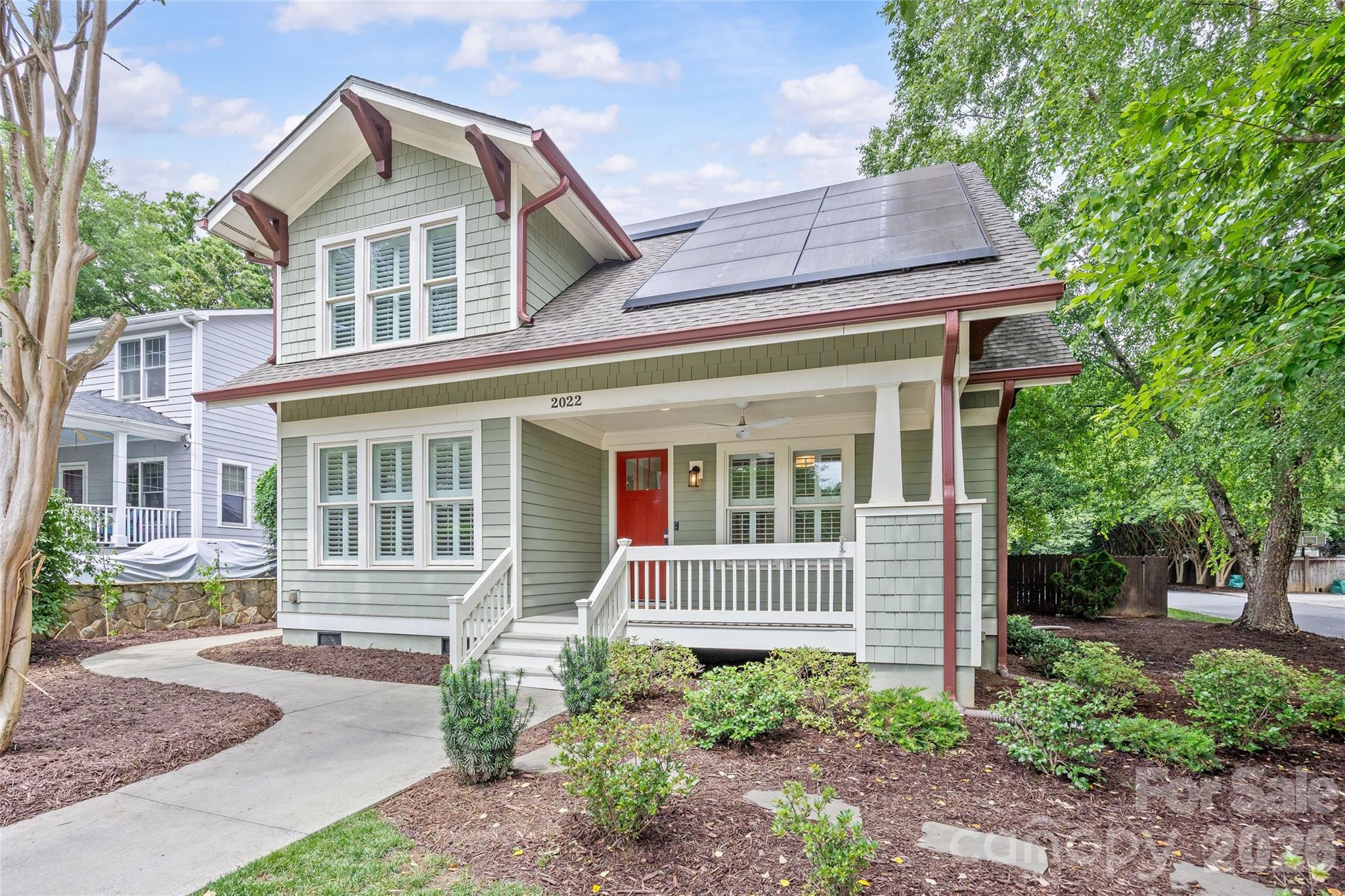 Step into 2022 Springdale Ave, a captivating Dilworth residence that seamlessly blends classic charm with modern comforts. From the moment you enter, sunlight floods the open living spaces, highlighting hardwood floors, built-ins, and elegant finishes that create a welcoming ambiance for both everyday living and entertaining. The main-level primary suite is a serene retreat with dual closets and a spa-inspired bath, offering a private sanctuary for rest and rejuvenation. Upstairs, a second suite-style bedroom provides flexibility for guests, a home office, or private living quarters. Step outside to your own backyard haven: a fully fenced yard with a heated in-ground pool, patio spaces, outdoor half bath, and mature landscaping, perfect for gatherings or quiet afternoons in the sun. Beyond beauty and comfort, the home features a solar panel system with battery backup, providing energy efficiency and true peace of mind. Additional amenities include three off-street parking spaces and an EV charging station. Ideally located near neighborhood dining, boutique shops, parks, SouthEnd, Uptown, and light rail, this home offers a lifestyle of convenience, tranquility, and enduring charm.