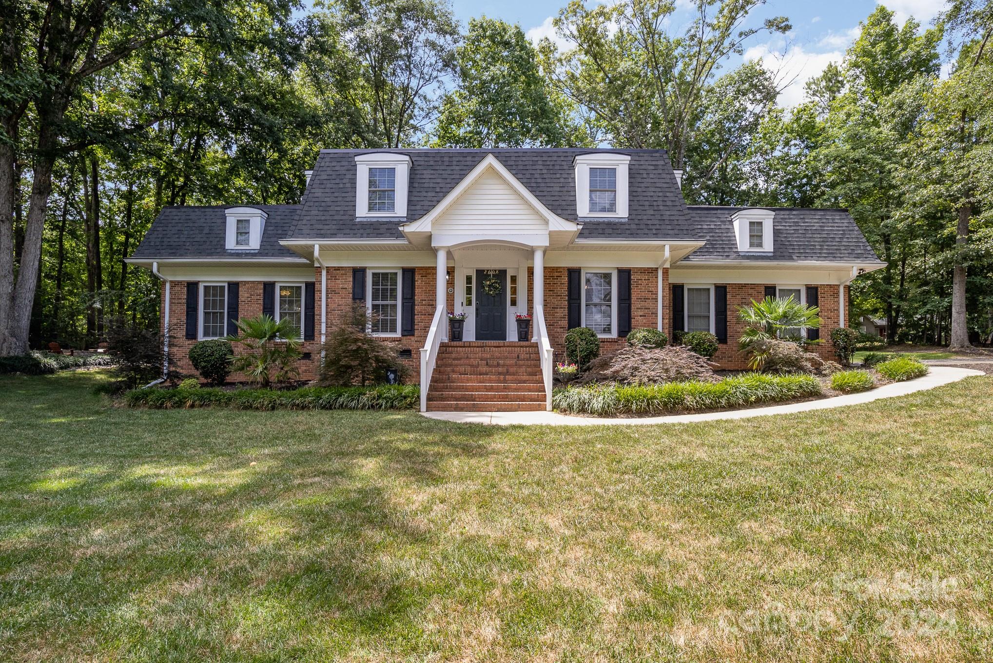 Welcome to your dream home! This exquisite 5-bedroom, 3-full-bathroom residence is nestled on a beautifully landscaped 3/4 acre lot in the desirable Rock Hill area. Featuring a spacious primary suite on the main floor with an updated en-suite bathroom, this home is designed for luxurious living and convenience. Step into the heart of the home – a fully updated kitchen, perfect for culinary adventures and family gatherings. The private backyard is a true oasis, offering ample space for outdoor activities and relaxation. Whether hosting a summer barbecue or playing catch, this yard is sure to be a favorite spot for family and friends. This home is walking distance to the swim/tennis club, providing excellent recreational opportunities just steps away. Plus, enjoy the ease of being just minutes from shopping, dining, the hospital, and I-77, making commuting and errands a breeze. Don't miss this opportunity to own a stunning home in one of Rock Hill's most sought-after neighborhoods.