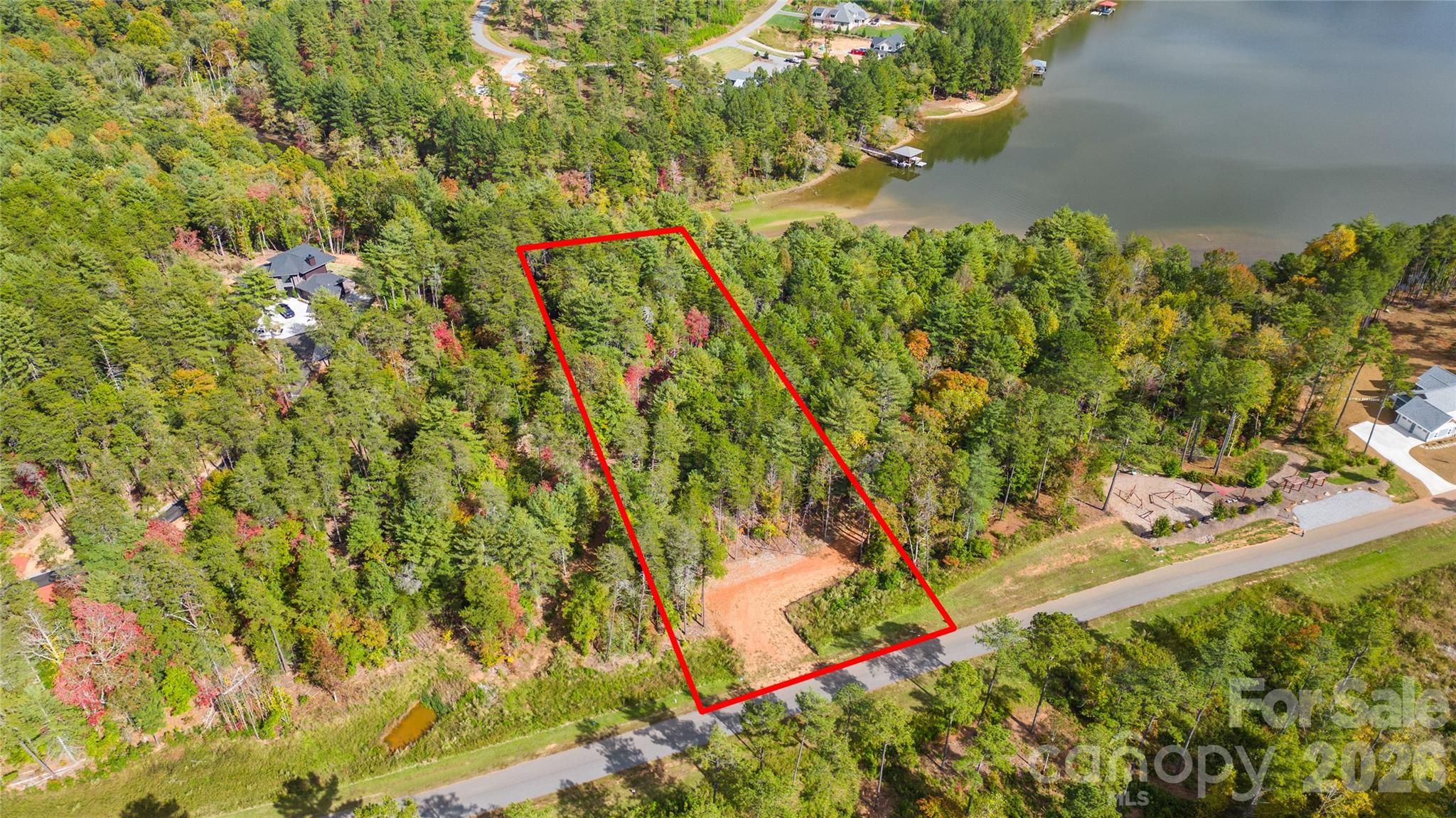 Below Tax Value!! Bring your own builder! Welcome to The Waterfront Club, a premier gated community on Lake Rhodhiss in Granite Falls, NC! This 1.21 acre build-ready lot features a pre-built driveway and peaceful water views - offering the perfect setting for your dream home! This particular lot is steps from the community playground and kayak launch! Other community amenities include a waterfront pavilion, private community dock, clubhouse w/ outdoor pool overlooking the lake, a sandy beach area, lakeside cabana, & walking trails. Minutes from Castle Bridge Marina! Whether you envision a year-round residence or a weekend retreat, this property combines convenience, natural beauty, and resort-style living!
