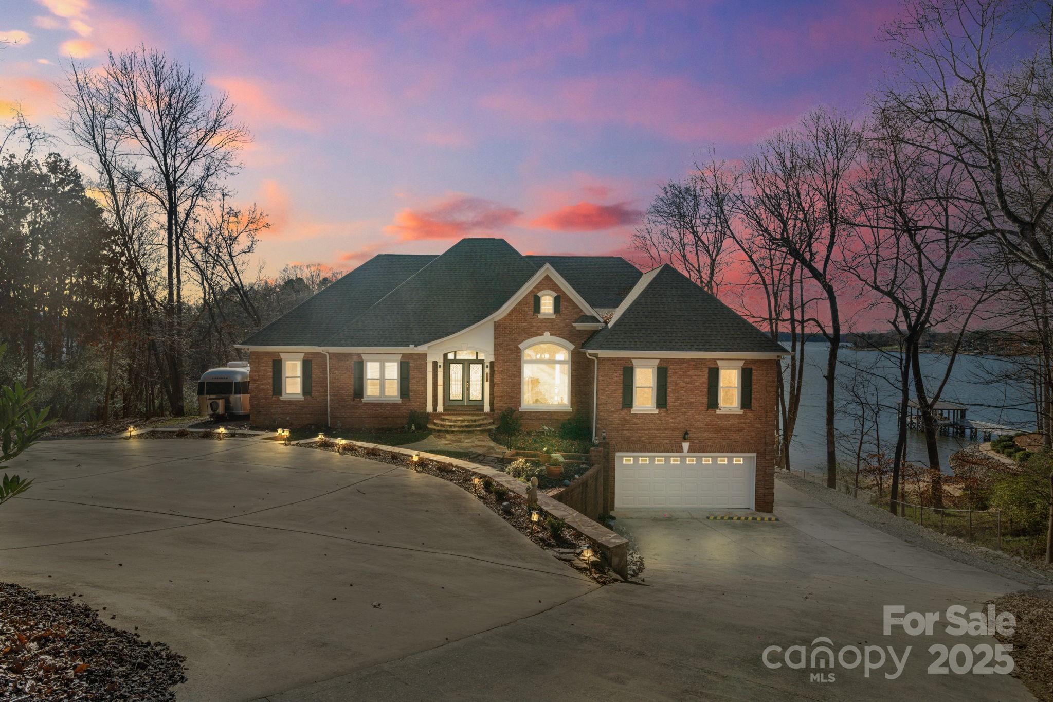 Experience unparalleled lakeside living! This recently updated retreat offers expansive lake views from almost every room. Large windows offer abundant natural light. Boasting two main-level primary suites, this home provides comfort and privacy for all. The spacious kitchen features a large island, gas range, beverage fridge, and gathering spaces. Expansive Trex deck to enjoy sunset lake views. Finished walk-out basement is an entertainer’s haven, complete with a bar and game room, tons of storage, full bath, and bonus room could be 5th bedroom. The fully finished oversized 2-car garage offers additional storage. Outside has everything you need - enjoy a dedicated pad for your RV/trailer, outdoor grilling/dining area, covered patio with hot tub, fire pit, shared beach area, and stationary Trex covered dock with boat lift and jet ski ramps. Great Mooresville location with no HOA. Don’t miss your chance to own a slice of lakefront paradise! This home could be sold fully furnished.