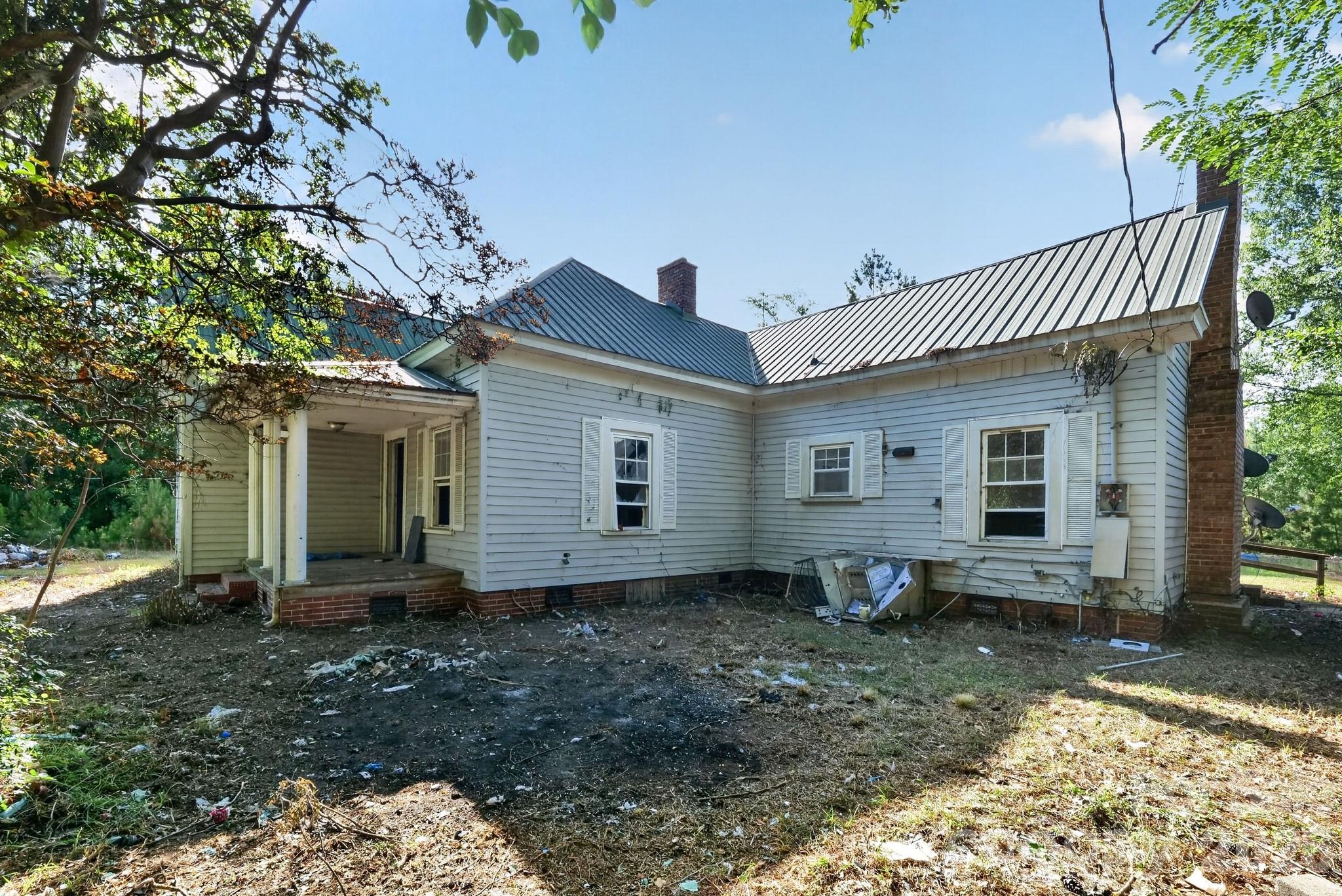 Investor and renovation opportunity on approximately 7.47 acres in Wadesboro. County records reflect two dwelling records, including a 2002-built dwelling with approximately 1,944 square feet, 5 bedrooms, and 3 baths, plus an additional older dwelling/structure of approximately 1,418 square feet. The property also includes utility/outbuilding improvements and a manufactured home site per county records.
This property needs substantial renovation and is being sold strictly as-is. The main structure shows significant interior damage and will require major repairs. Strong upside for a buyer looking for acreage, multiple existing improvements, storage, homestead potential, rental potential, or a full renovation project. Seller makes no representation as to condition, utilities, habitability, permits, or future use. Buyer to verify all square footage, bedroom/bath count, structure status, utilities, zoning, and intended use with Anson County. Cash or renovation financing likely required.