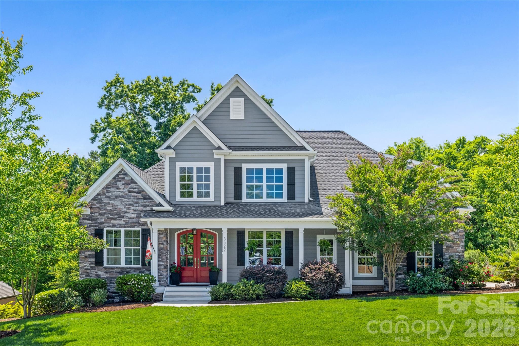 This exceptional custom-built home blends timeless elegance with modern luxury, designed for both refined entertaining and comfortable living. A dramatic two-story entry creates an unforgettable first impression, leading into a stunning great room with soaring cathedral ceilings and a striking stacked-stone fireplace.

The chef’s kitchen is the heart of the home, featuring premium appliances including an induction cooktop, double ovens, an expansive island, and exquisite Brazilian marble countertops — perfect for hosting gatherings or enjoying everyday moments with friends and family.

The main-level primary suite offers a private retreat with tray ceilings, triple windows overlooking the wooded backyard, plush new carpeting, a spacious walk-in closet, and a spa-inspired bath complete with a large dual-head shower, an impressive 12-foot vanity with seating area, and generous linen storage. The conveniently located laundry room is just steps away. A secondary bedroom on the main level provides flexibility as a guest suite, executive office, or playroom.

Upstairs, a large bonus room and two oversized bedrooms create the ideal space  to hang out. New tankless water heater was installed in 2025. 

Outdoor living is equally inviting, with a charming front porch and a private rear deck surrounded by mature trees. Additional highlights include an oversized garage and abundant parking for family and guests.

Located within the highly sought-after, award-winning Clover School District, including new Lake Wylie High School, this home also offers convenient access to the lake,  neighborhood clubhouse, pool,  shopping, dining, and everyday conveniences.