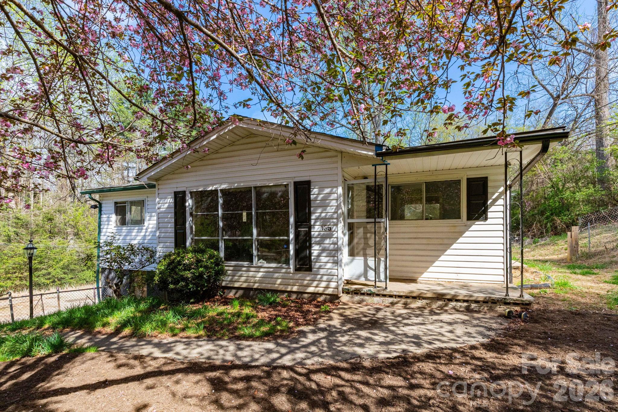Unlock a rare high-yield investment opportunity in the sought-after Enka area of Asheville. Situated on 2.06 acres, this versatile property includes a single-family home plus five mobile home lots—three with existing homes included—offering multiple income streams and significant upside potential.

Based on previous and current market rent projections, the property has the potential to generate approximately $85,200 annually in its current state, with estimated expenses of ~$11,470/year, resulting in a projected NOI of nearly $74,000. 

Value-add opportunities include increasing below-market rents, filling two vacant mobile home pads, and leasing the garage/shop for additional income. Light improvements such as paint, flooring, and system updates could further enhance rental performance and overall value.

Conveniently located just 5 minutes to Brevard Road and Asheville Outlets, 10 minutes to North Carolina Arboretum and Blue Ridge Parkway access, and 15 minutes to Downtown Asheville, this property offers strong rental demand drivers and long-term growth potential.

Main home does not currently have a functioning heat source, but seller will install baseboard heaters if required for a loan. A compelling opportunity for investors seeking to create value and build cash flow in one of Asheville’s most accessible and desirable areas.
