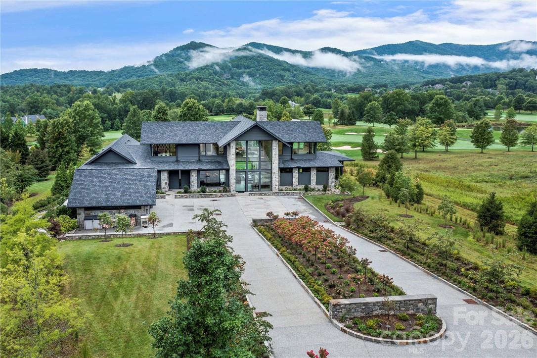 Defining modern luxury in Asheville, this home is a custom-built masterpiece that is perfectly situated within the prestigious gates of The Cliffs at Walnut Cove. This architectural marvel overlooks the Jack Nicklaus Signature Golf Course with the Blue Ridge Mountains serving as a breathtaking backdrop. The home’s design is a study in light and scale, featuring soaring ceilings and a staggering number of windows that immerse the interior in natural radiance. Most notably, the residence boasts three of the largest single-pane windows found in any residential property in North America, blurring the line between the refined interior and the rugged mountain landscape.

The main level is anchored by a primary suite of unmatched scale, thoughtfully designed with a personal sitting room, a custom-crafted bath suite, and an expansive walk-in closet. Designed for both grand entertaining and effortless hosting, the home offers an abundance of guest rooms and multi-use spaces throughout. The lower level serves as a private sanctuary of its own, featuring a 1,500-bottle wine cellar and dedicated space for an in-house caretaker. From the sleek steel architecture to the high-efficiency geothermal systems, every detail of this estate reflects a commitment to functional elegance.

Beyond the threshold, the property transitions into an outdoor oasis complete with a private deck and large fire pit, all while offering front-row views of the course. Residents enjoy world-class community amenities including a sprawling wellness center, tennis courts, and miles of private hiking trails. Offering the rare combination of high-altitude privacy and urban accessibility, this quintessential mountain retreat is located a mere ten minutes from the Asheville Regional Airport.