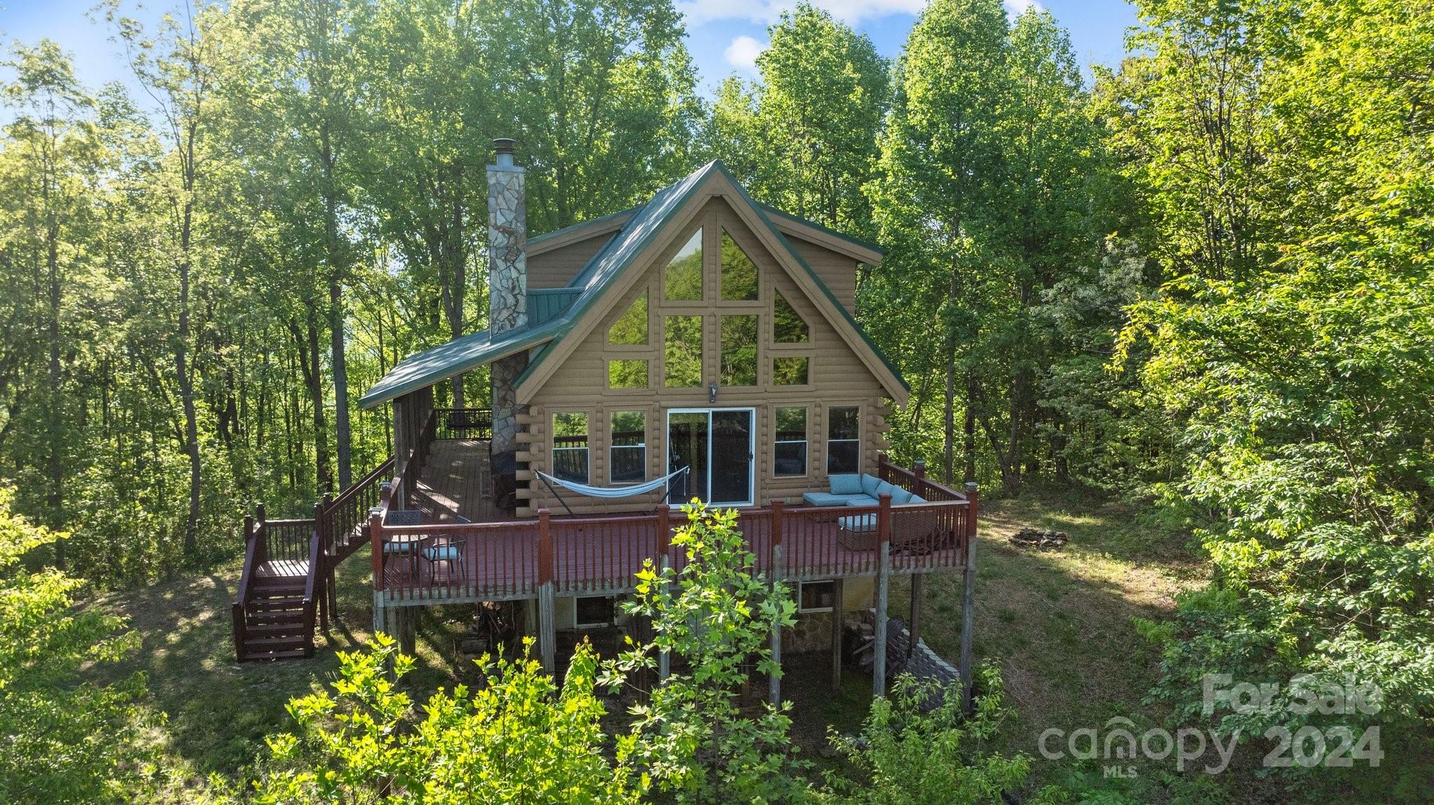 This PRIVATE 10.58 acre lot and 2 story cabin with a wrap around deck will provide the getaway you have always been looking for! This log home features 2BR and 2BA (3rd bedroom/office) with a loft, and an unfinished basement. The basement has electrical and plumbing accessible so that this space can be easily finished.The first floor boasts a woodburning fireplace, and a 2 story family room with floor to ceiling glass windows for an amazing view! Kitchen comes equipped with a refrigerator, an electric range, dishwasher, and microwave.This home is being offered mostly furnished and also includes the washer and dryer. This home can work as a weekend getaway or primary residence. Close to Forest City,Lake James,South Mountain State Park, and Asheville. Minutes from Jellystone Campground where you can get a day pass. Internet via satellite or fixed wireless. Golden Valley Estates is a gated cabin community.Schedule your showing today and start enjoying your new retreat!
NO STR's allowed.