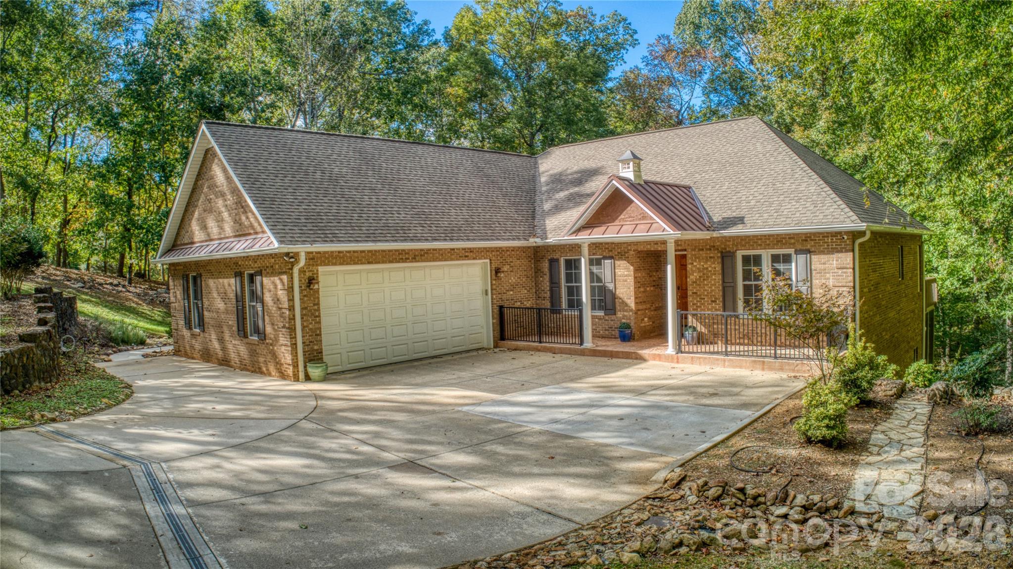 Welcome to 906 Rocky Cove Ln –Nestled within the gated community of The Springs, this beautiful 3-bedroom, 3.5-bath home is set on 2.59 acres with lake views and deeded boat slip.Step inside to discover hardwood flooring, vaulted and tray ceilings, and a wood-burning fireplace. The spacious primary suite offers a peaceful retreat with walk-in shower, and garden tub..Enjoy morning coffee or evening sunsets from the inviting sunroom or choose between two decks overlooking the water. The natural stone walkways and retaining walls that surround the home blend perfectly with the tranquil setting.The fully finished lower level offers endless possibilities—featuring a potential 4th bedroom, full bath, kitchen, office, workshop, and a gas log fireplace, making it ideal for guests, multigenerational living, or a home business setup.Whether you're looking for a weekend retreat or a full-time residence, this property offers the perfect blend of comfort, privacy, and access to lake life.