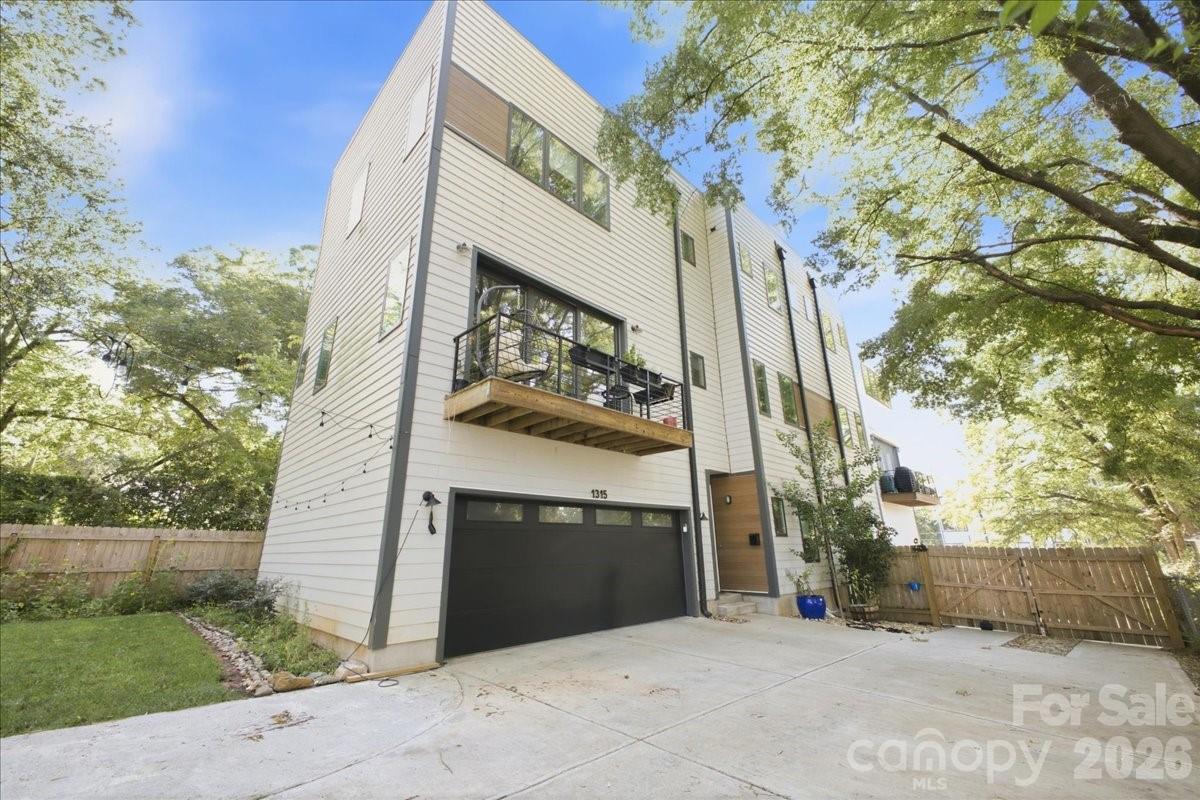 Welcome to luxury urban living in the heart of Optimist Park! This stunning three-story townhome offers over 2,100 square feet of thoughtfully designed living space with 3 bedrooms, 3 full baths, and a half bath. The open-concept main level features soaring ceilings, abundant natural light, hardwood floors, a designer kitchen with quartz countertops, a large center island, stainless steel appliances, and a spacious walk-in pantry—perfect for entertaining or keeping eyes on the little ones. 

Retreat to the private primary suite with a spa-inspired bath and all the closet space you could need - two generous walk-in closets and a linen. Outdoor living is unmatched with a fully fenced backyard featuring a cozy fire pit—perfect for relaxing or gathering with friends. The expansive rooftop terrace takes entertaining to the next level with a hot tub, built-in grill, and an additional fire pit, creating the ultimate space to enjoy Charlotte’s skyline and beautiful evenings.

An attached two-car garage provides convenience and additional storage. Located just steps from Optimist Hall, the Lynx Blue Line, breweries, restaurants, coffee shops, and all that NoDa and Uptown have to offer, this home delivers the perfect blend of luxury, walkability, and low-maintenance living. Don’t miss your opportunity to own one of Charlotte’s most desirable urban residences!
