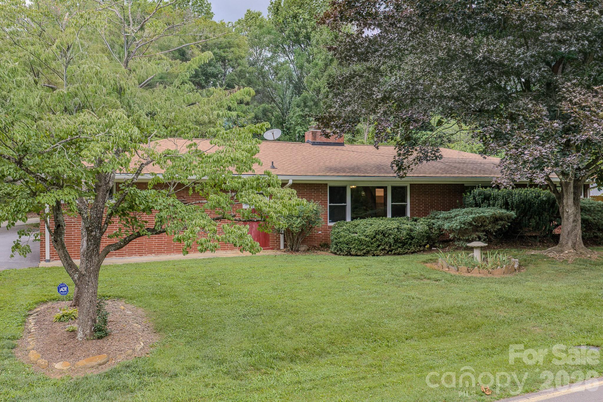 Rare opportunity to own a 4-bedroom, 2.5-bath mid-cent gem on Alexander Avenue in Grovemont-on-Swannanoa — part of one of America's first planned communities, developed by E.W. Grove beginning in 1924. This architectural treasure sits on a desirable corner lot and strikes the perfect balance between authentic mid-cent character and modern updates, featuring a refreshed kitchen and baths while preserving the original design integrity that makes these homes so sought after.
Practical updates are already done — roof replaced in 2018, a brand new privacy fence, and an extensively updated electrical system — making this one truly move-in ready. And with the seller offering $5,000 toward closing costs, stepping into this piece of history is more attainable than ever.
The historic Grovemont neighborhood offers a walkable lifestyle with the beloved Grovemont farmers market, library, and live music all within easy reach. And the neighborhood is only getting better. Beacon Park — a transformative new development on the site of the former Beacon Blanket Factory — is set to open just minutes away in 2026, bringing a world-class bike park, bouldering walls, a one-mile walking loop, playground, and a 4,000-person event lawn to Swannanoa. New local businesses including Short Sleeve Coffee and Ovenbird Kitchen are already open, with more on the way. This area is experiencing a genuine renaissance.
When you're ready to venture further, Biltmore Estate, the Blue Ridge Parkway, Black Mountain, and downtown Asheville are all just minutes away.
A coveted corner lot, a storied address, and a piece of American architectural history — all in one.