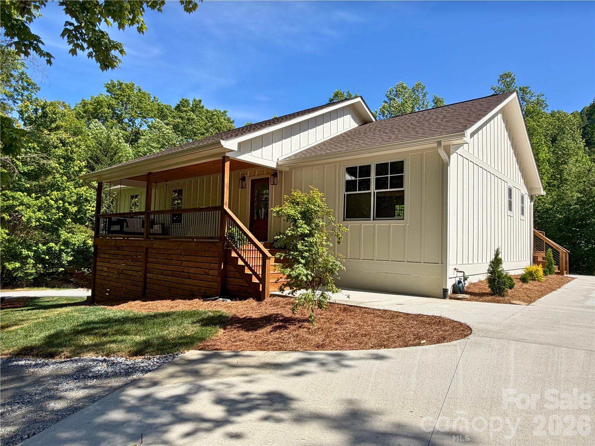 NEW! NEW! NEW!    Experience an Exceptional Fully Renovated in 2026 Mountain Cottage Farmhouse. This turn-key home features a new roof, new hardi-board siding, Pella aluminum-clad windows, two new HVAC systems, new gas tankless water heater and new appliances and so much more.


Nestled on 2.66 acres in the desirable Saluda area, this beautifully renovated farmhouse style home offers the perfect blend of modern comfort and timeless cottage charm.  Thoughtfully redesigned with a bright, open layout and high-end finishes throughout, this home welcomes you the moment you arrive.


A new driveway entrance leads to a spacious parking and new covered front porch–ideal for morning coffee or evening conversation.  Step inside through the handsome new wood farmhouse door into a warm and inviting interior. 


The completely new kitchen is a showstopper, featuring soft sage semi-custom cabinetry. A custom range hood, elegant granite countertops, and charming V-groove wood accent walls that create an authentic cottage atmosphere.  

Adjacent, the living room invites you to slow down and unwind with the custom brick gas fireplace and built-in cabinetry. Rich wood accents continue throughout, highlighted by new Pella wood windows and beautiful mantel. 


The primary bedroom suite continues the cottage theme with its own V-groove wood accent wall, while the spa-like primary bath offers a luxurious soaking tub and a large tiled walk-in shower.  Two additional bedrooms and guest bath with a cheerful blue vanity, tile floor completes the main level.  


The fully finished basement provides excellent versatility perfect as an efficiency mother-in-law suite, a short-term rental opportunity, or a fantastic family space with game room, TV area, and kitchenette. Offering a separate exterior entrance and private patio off the dining area make it ideal for guests or rental income.  The lower level also includes a full bathroom and is finished with durable, easy maintenance Mohawk LVP flooring. 


Outside, the brand-new board-and-batten siding and fresh exterior create classic farmhouse curb appeal, enhanced by the new covered porch and back deck. Enjoy the outdoor living with a lower creek, a fire pit area, and plenty of room for gardening or simply taking in the wooded views and wildlife.


Located in a wonderful mountain neighborhood, you’re just minutes from downtown Saluda, Hendersonville and short drive to Greenville, SC

A rare combination of quality renovation, thoughtful design and mountain setting awaits.

Important note: This home is served by a 3-bedroom septic system.

Some photos have been digitally enhanced.