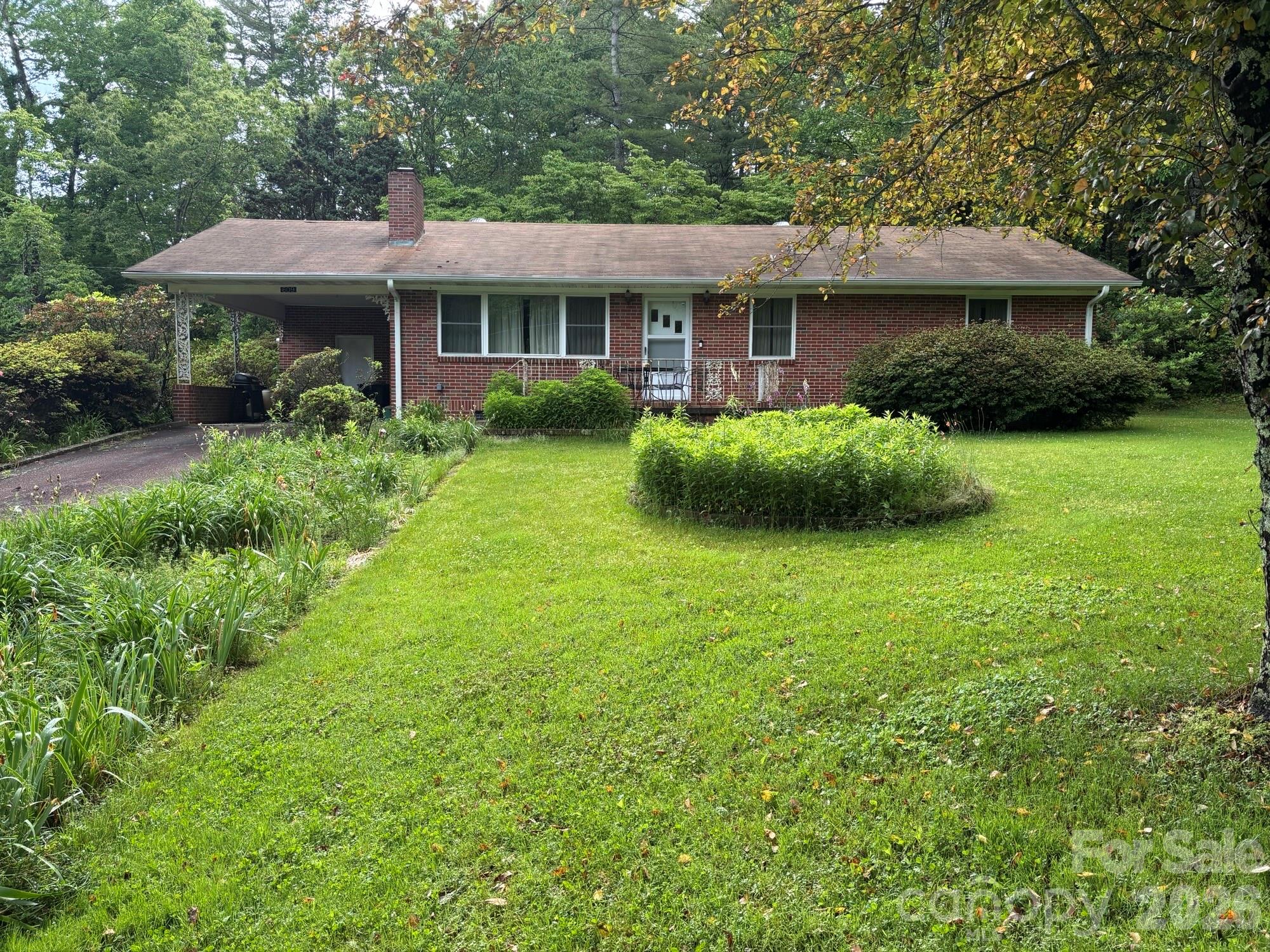 This brick ranch home is just waiting for you. 3 bedroom 1 bath home needs some TLC but seems to have great bones. Some original hardwood floors which you can bring back to their original beauty. Windows have been updated.  Sitting on 1.5 acres of land which is a flower lover's dream. Many verities of flowers but many varieties of day lilies. The original owner was a master of the day lily. Selling "AS IS". There is a camera on the property.