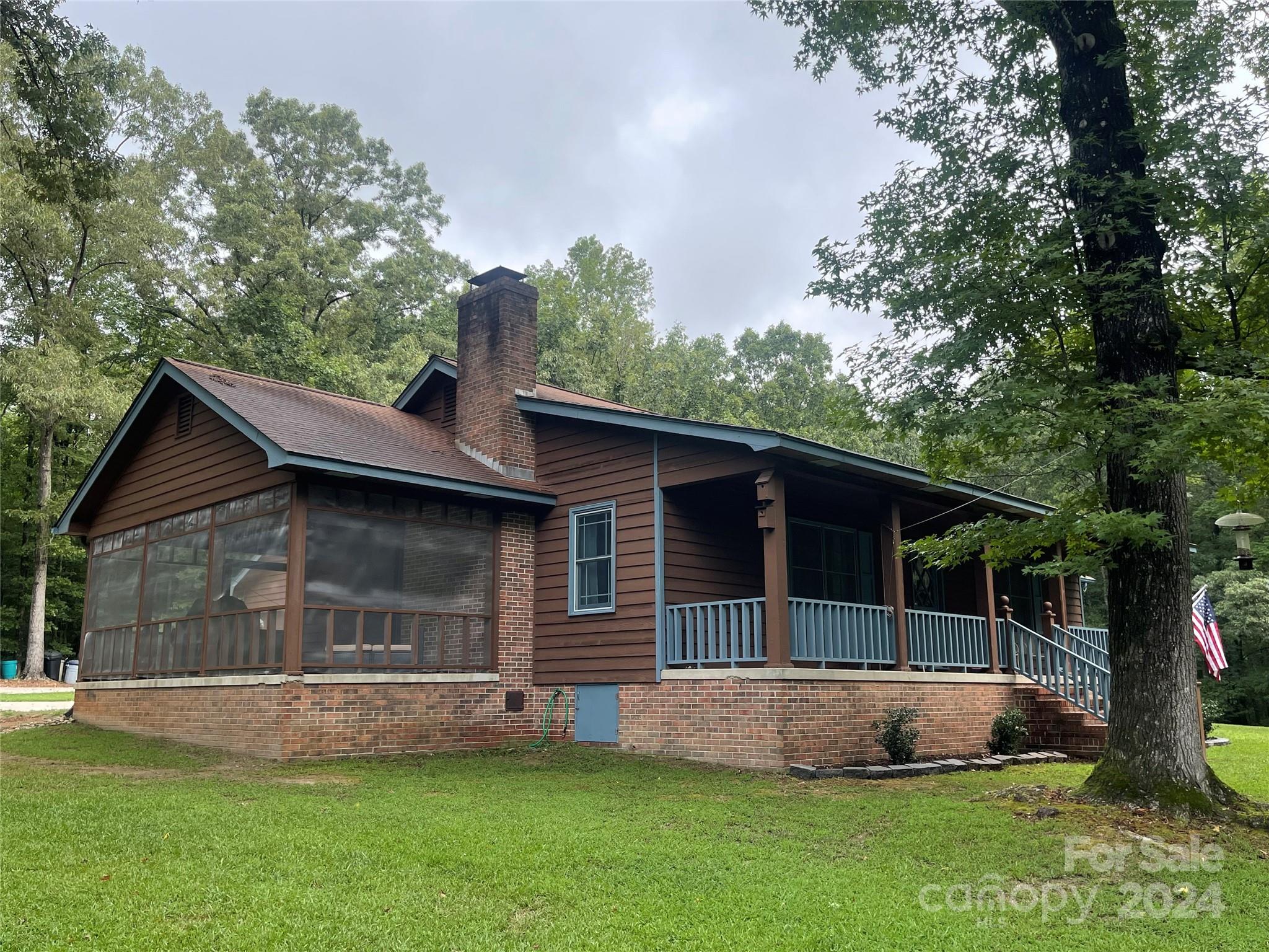 LOOK NO FURTHER ! It's RARE to find a beautiful cedar siding county home nestled on a dead end street with 8.12 ACRES. The winding driveway entrance opens up to lush green grounds and towering trees ...SO peaceful and serene...Really beautiful !!! 
The home offers 3 bedrooms, 2 full baths....formal dining room and room enough for a small table in the kitchen...Master bathroom  recently renovated. NEW granite in kitchen and both baths. Tankless water heater.
Large wood burning fireplace in the family room with gorgeous flooring.... Relax on the front porch with total privacy OR take a nap or maybe fire up the grill for family gatherings on the spacious screened in porch off to the left side of the home. 
Fenced area for your pets and a nice size workshop / storage building.2 car garage. Refrigerator, stove and microware stay.