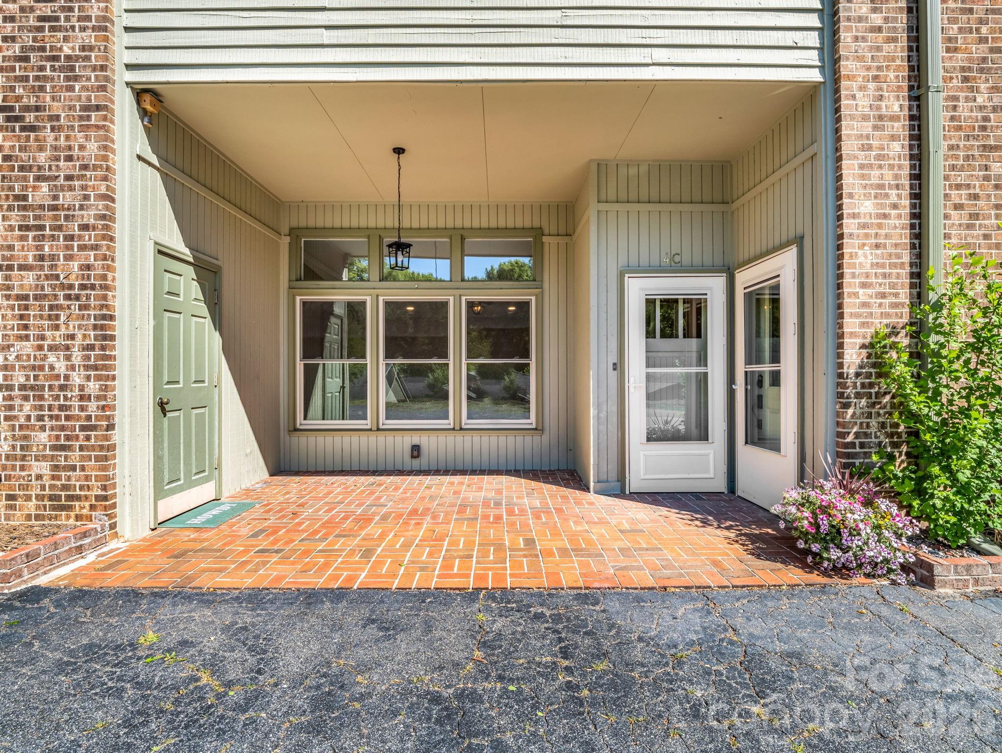 Completely renovated and move-in ready, this stunning Tryon condominium is ideally located just minutes from downtown shops, restaurants, galleries, and the future Saluda Grade Rail Trail. Thoughtfully redesigned from top to bottom, recent upgrades include luxury wide-plank vinyl and tile flooring throughout, radiant heated floors in the primary bath, beautifully tiled showers in both bathrooms, updated lighting and plumbing fixtures, a new hot water heater, fresh paint and wallpaper, removal of popcorn ceilings, and new solid-core interior doors with custom exterior doors, upgraded hardware, and keypad entry.
The bright and welcoming living room features an electric fireplace and flows seamlessly through a wide archway into the dining area with an antique chandelier and the fully updated kitchen. Designed for both style and function, the kitchen offers quartz countertops, a breakfast bar, stainless steel appliances, and double stainless sinks.
A short hallway leads to the beautifully remodeled guest bath featuring tile floors and tub surround, antique mirror, designer wallpaper, and updated fixtures. The spacious primary suite includes two closets, a convenient laundry area, and a luxurious ensuite bath with heated tile floors, updated vanity, designer wallpaper, and a tiled shower with teak seating and custom glass door.
An additional office/bonus room with two large closets provides flexible space for a den, office, craft room, or guest accommodation. Offering like-new condition and exceptional proximity to all the charm and amenities of downtown Tryon, this beautifully updated condo is a rare find.