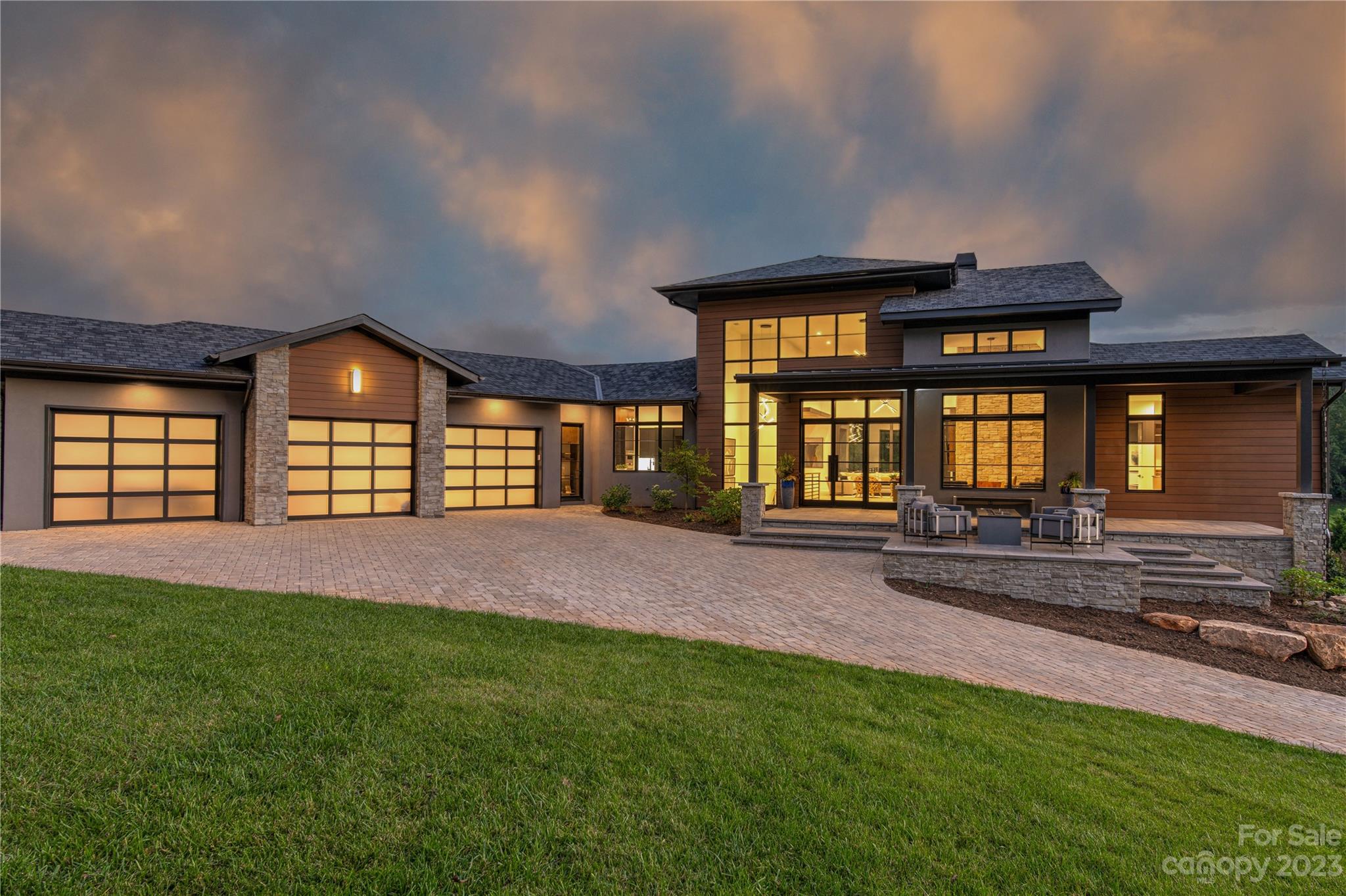 Come home to The Cliffs at Walnut Cove, a luxury gated golf and wellness community located in Asheville, North Carolina. This model home is sleek with a contemporary design and transitional spaces. Outside, there is a large front porch featuring a fire table to enjoy a view of the golf course. Once inside, an impressive tall foyer leads to a main living area with a linear gas fireplace, glass-cornered den and glass stacking doors that open to the wide rear porch. The covered porch features retractable screens, an outdoor kitchen and a see-through fireplace shared with the Owner's Suite porch. The main level features a gourmet kitchen and a large prep kitchen. The lower level provides abundant entertainment spaces for guests, with a billiards room and club room, featuring a wet-bar and walk-out covered porch. A Club Membership at The Cliffs is available for purchase with this property giving you access to all seven communities. 9-month leaseback agreement required. Inquire for details.