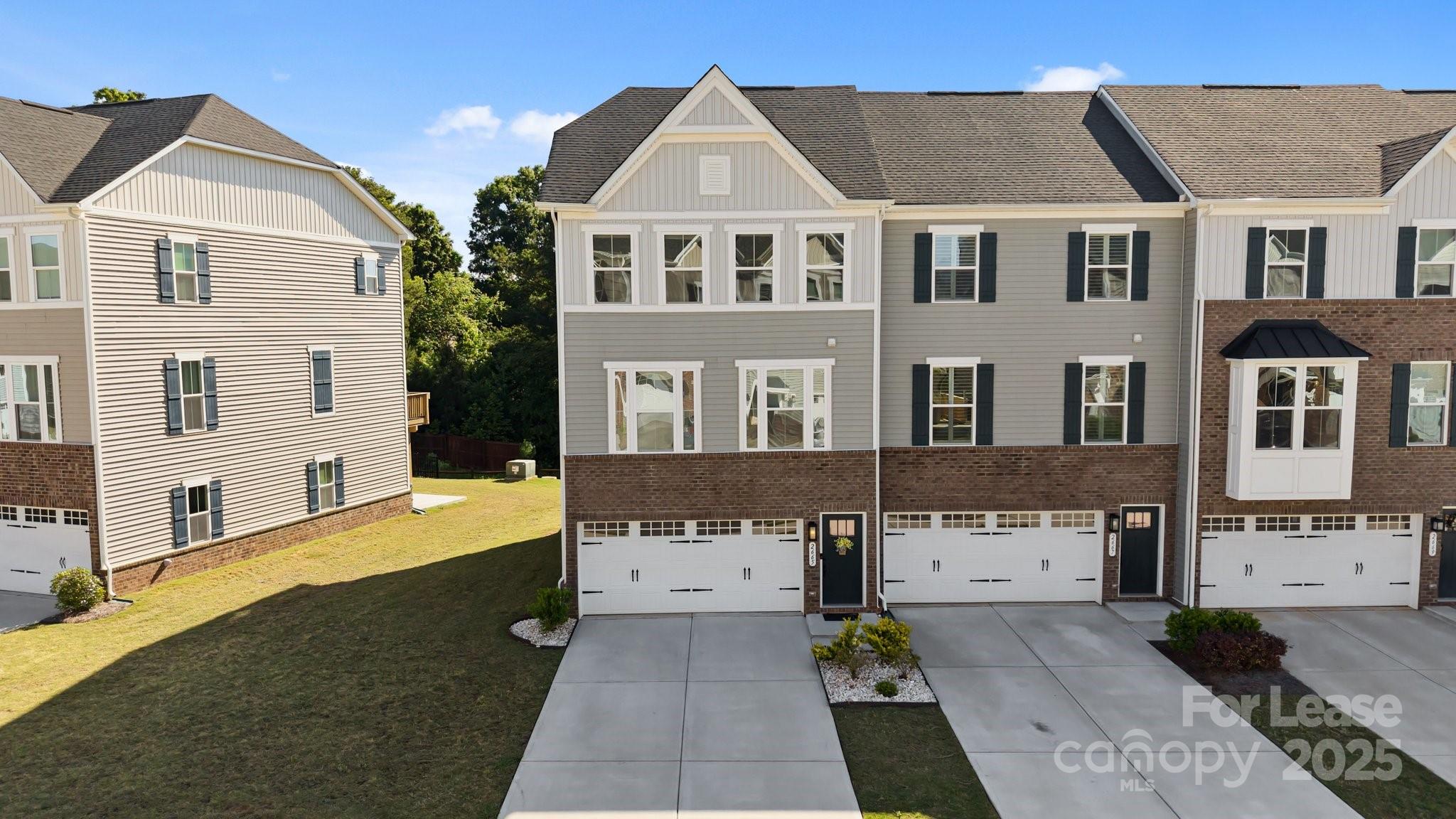 Welcome to this beautifully maintained end-unit townhome in a gated community nestled in the heart of Fort Mill. This end-unit with extra windows features a large side yard, private backyard w/ patio, and a scenic lake view perfect for entertaining, or simply relaxing in your own oasis. Epoxy finished 2 car gar and driveway space for 4 cars. 1st floor has a large rec room w/ LVP flooring & a sliding door to the backyard. The main floor w/ LVP flooring has an open floor plan. kitchen w/ extended island & quartz countertops and SS appliances. Dining area opens to the back deck with a beautiful pond view from the deck. The deluxe owner’s suite on the third floor features an oversized walk-in closet. Primary bath w/ dual sinks & upgraded shower. Two more large-sized BR located upstairs, 9’ ceilings on both upper floors. Award-winning Fort Mill schools, easy access to highways I-77, I-85, I-485. Community amenities include swimming pool, playground, tennis, pickleball and basketball courts.