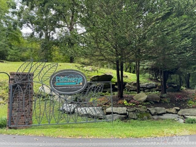 This beautiful building lot is located in the upscale neighborhood of Pathways of Solomon Jones. The driveway has been recently improved, providing easy vehicle access to a level building site with a convenient turnaround area. Previously overlooked, this lot now offers a clear view of its potential as a prime location for your dream home. The property's position, near the neighborhood entrance, provides both convenience and easy access. The building site also offers potential views and is surrounded by abundant mountain laurel. Pathways of Solomon Jones is situated near historic downtown Hendersonville, providing close proximity to dining, shopping and the Ecusta Trail. The lot owners are builders and are available, should you choose, to help you build your custom home.